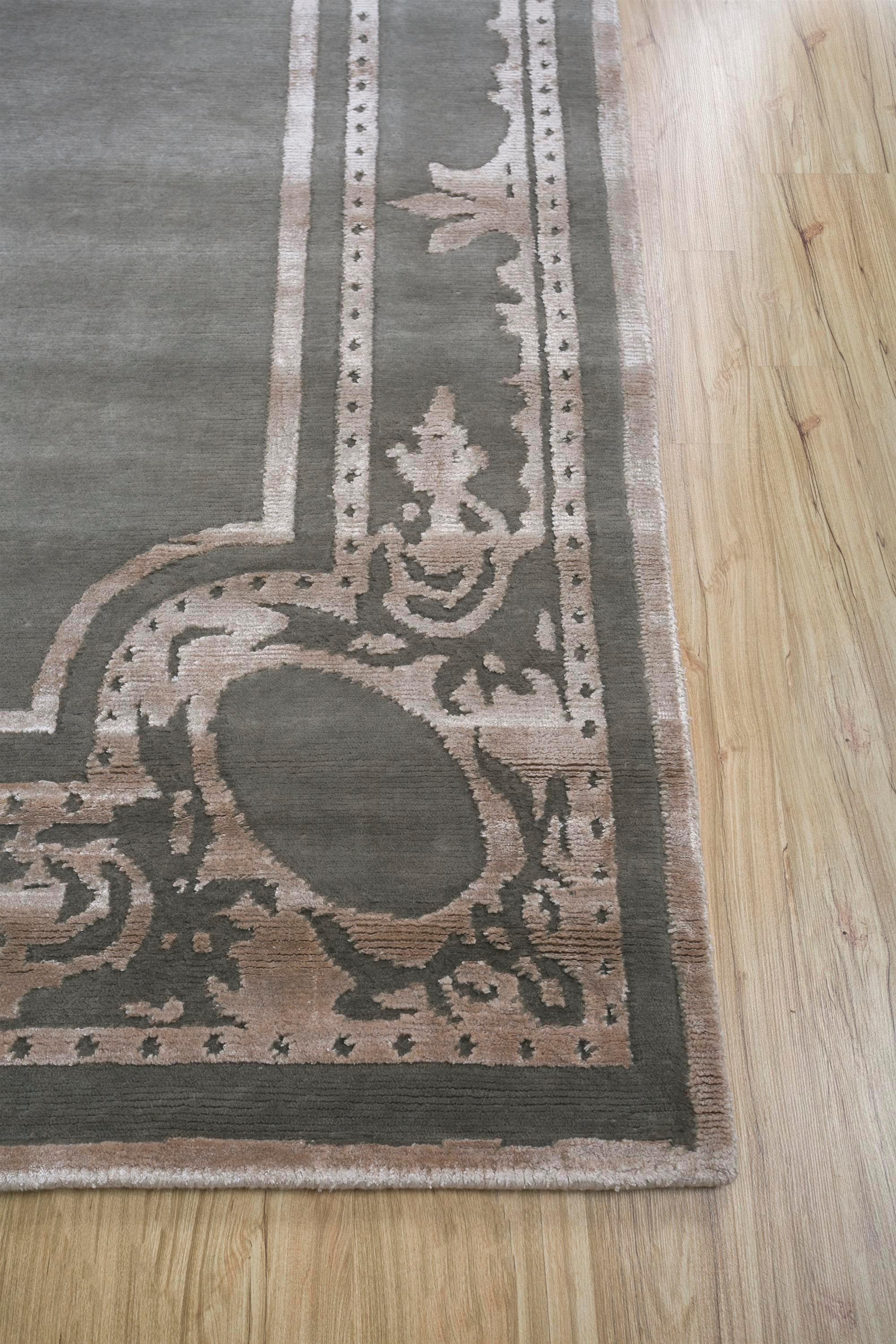 Can a rug redefine the ambiance of your space? Meet this modern, hand-knotted rug . Grounded in a tone-on-tone palette with nickel as its base and a light coffee border, it effortlessly uplifts the mood of any room. Handmade in rural India, this rug