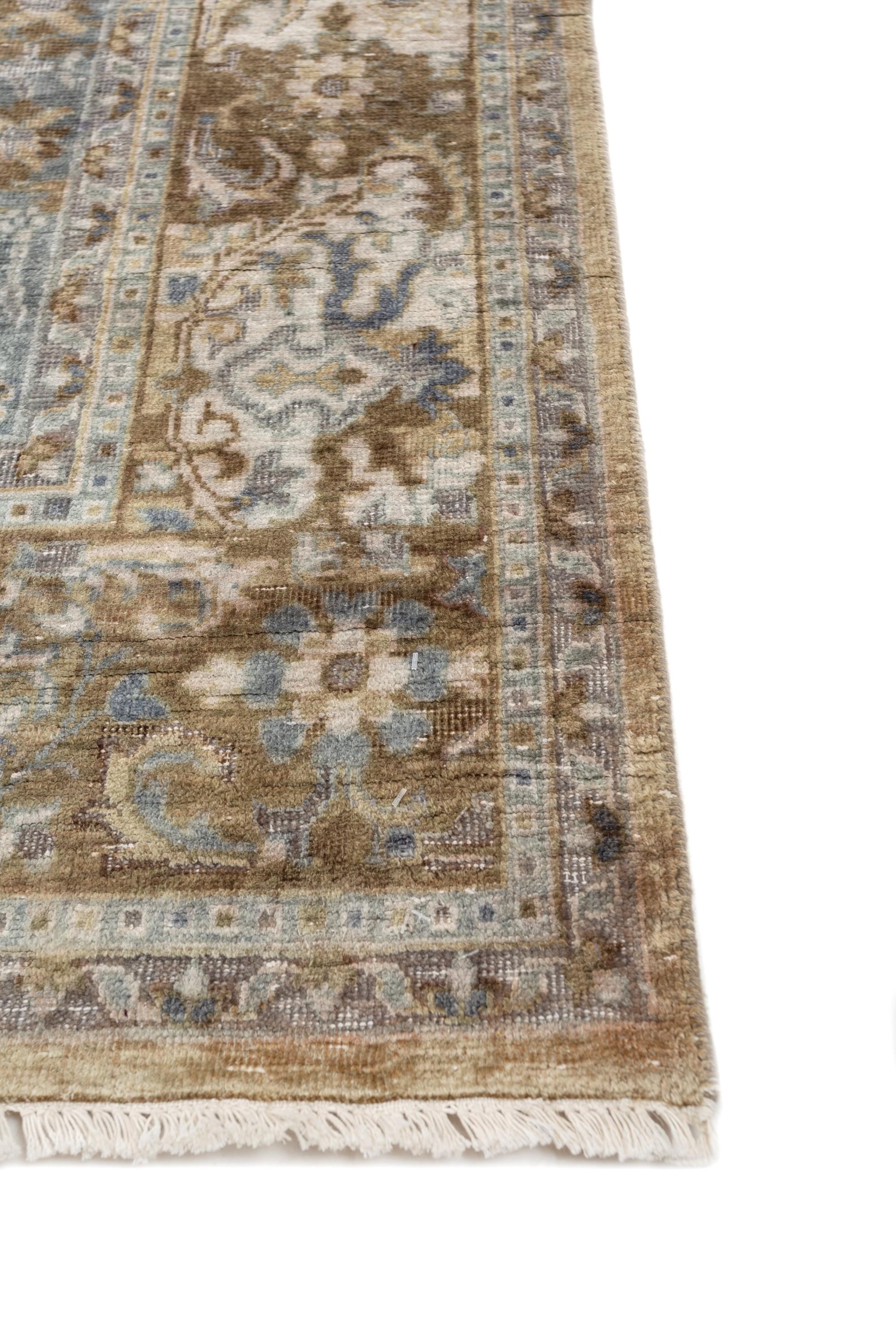 Immerse your space in the grandeur of this transitional hand-knotted rug that transcends time and decor styles. Handmade in rural India, this masterpiece features traditional patterns, invoking an aura of spectacular opulence and majestic shades.