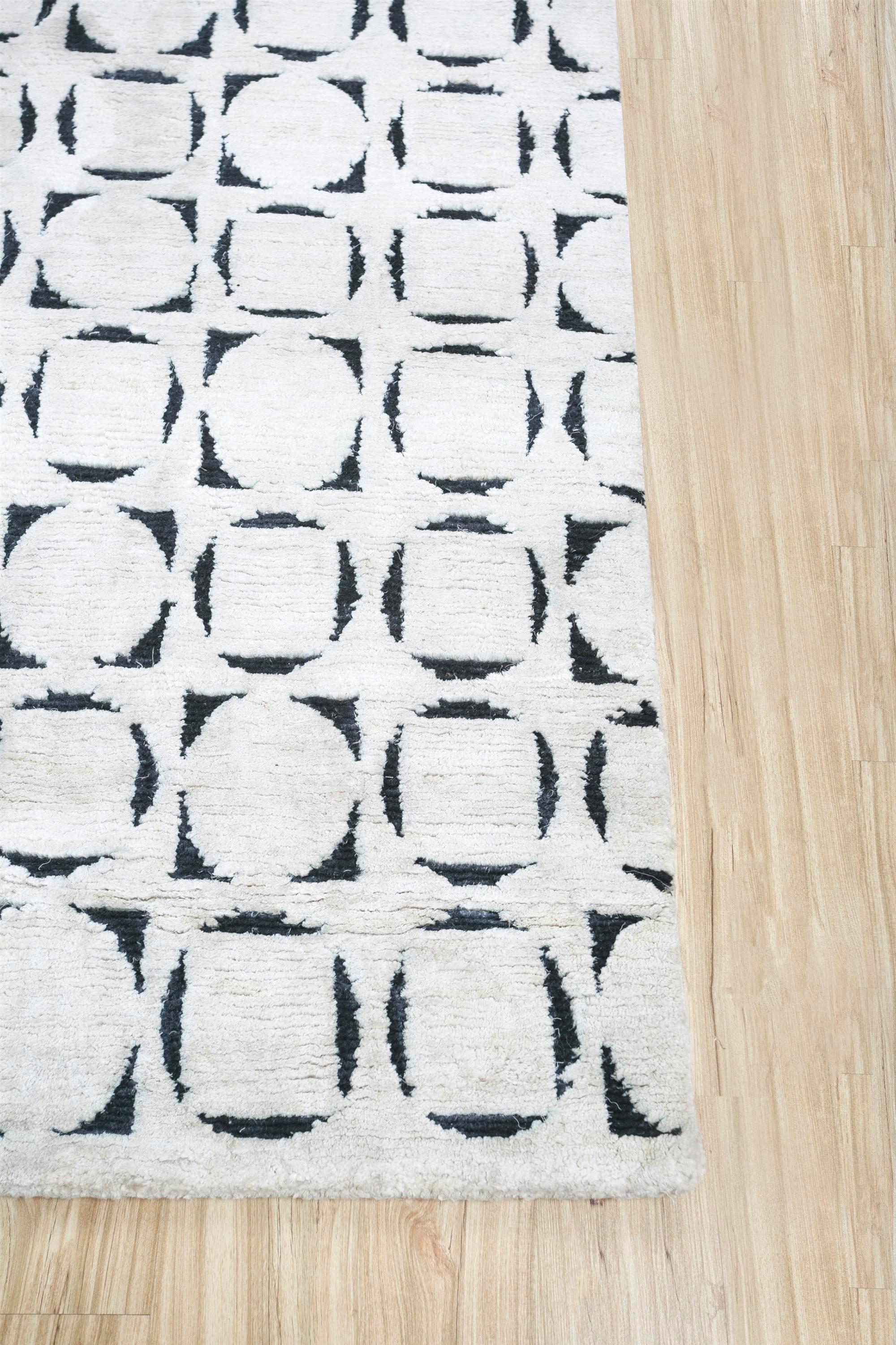 Are you looking for a handmade rug that can be the transformative touch your space craves? Dive into the exquisite allure of this modern hand-knotted rug . Meticulously crafted in rural India, it is enveloped in a soothing tone-on-tone palette. Its