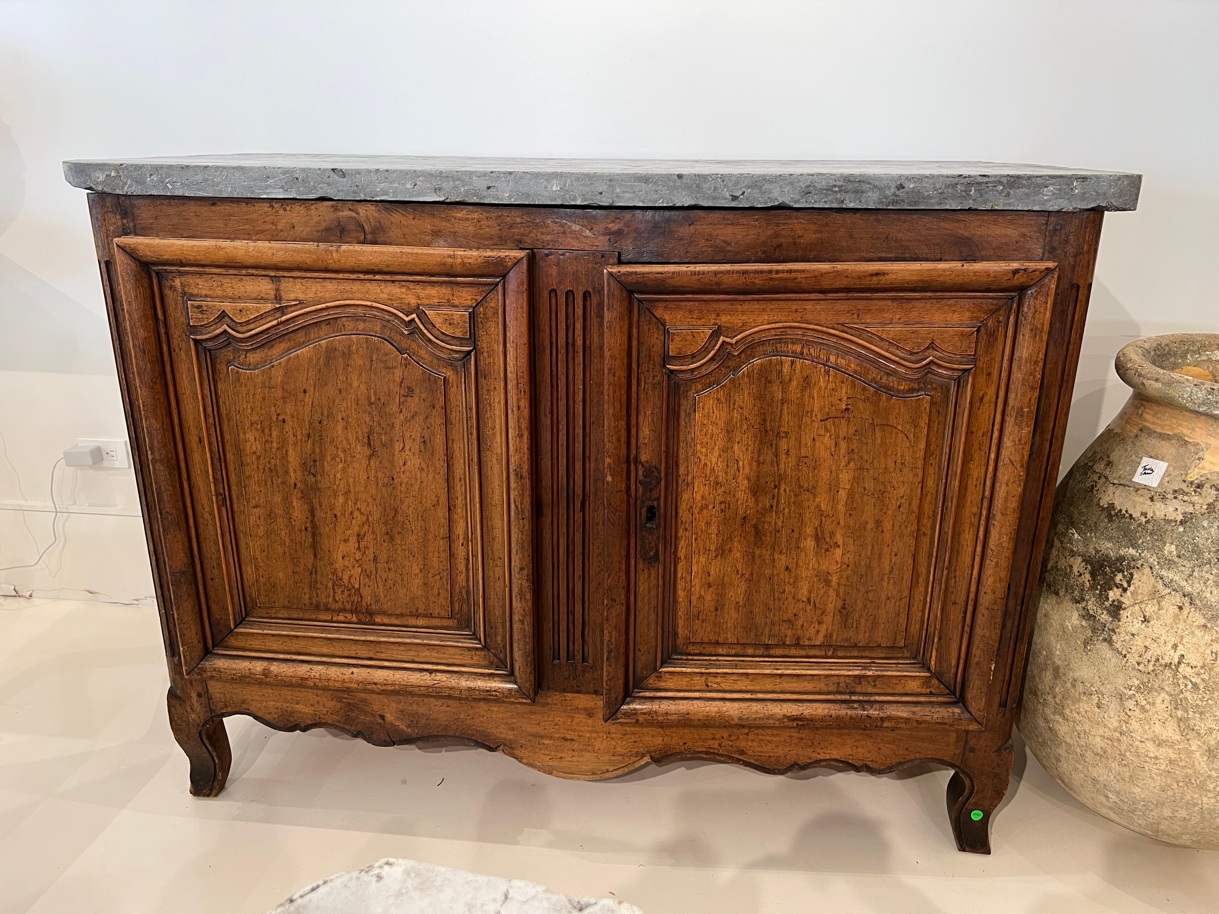This buffet has two large doors and an imposing slate colored marble top.  The height is a bit taller than normal which gives it an important presence.  When you open the doors there is a small drawer behind each one.  A wonderful storage piece.