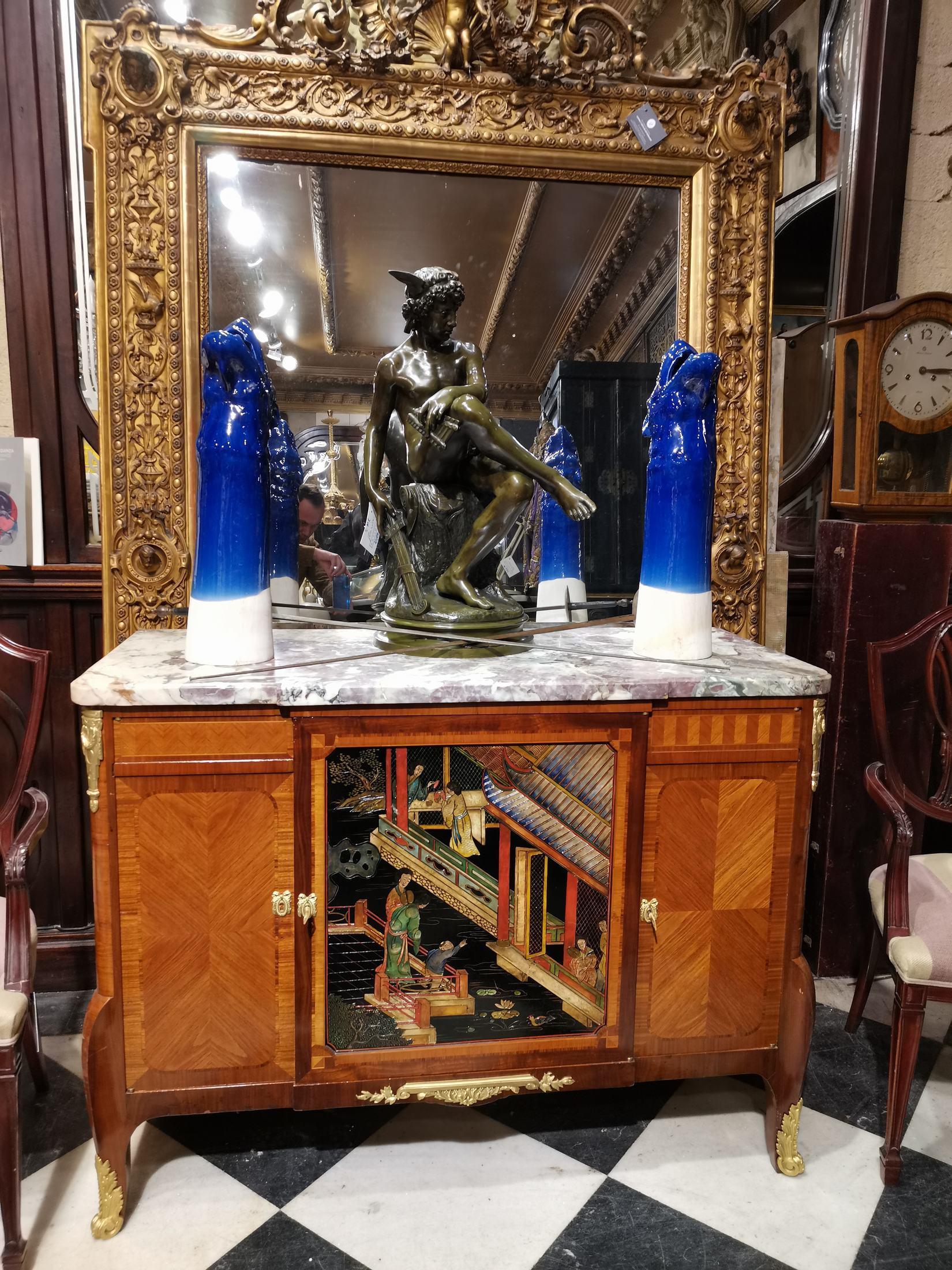 Beautiful Transition style chest of drawers with arched legs. It opens with two Coromandel lacquer doors decorated with characters. Rich ornamentation of gilded bronzes: falls, key, keyhole, apron, clogs. Amaranth veneer, oak frame. Marble top