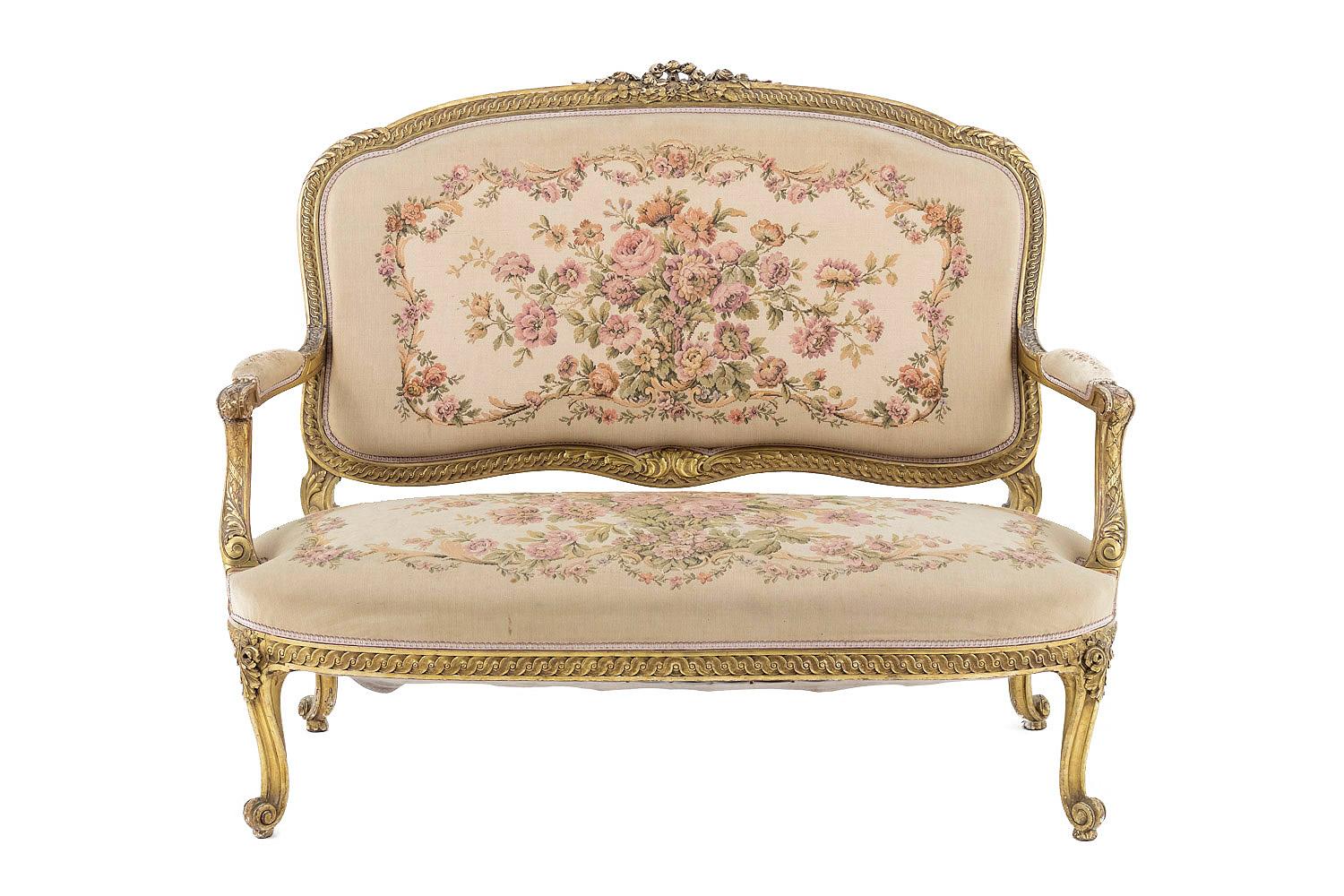 Transition style sofa in giltwood standing on four cabriole legs ending in scroll with a decor of acanthus leaves. Slightly bulged apron adorned with an interlacing frieze. Arm supports slightly behind the leg line adorned with acanthus leaves,