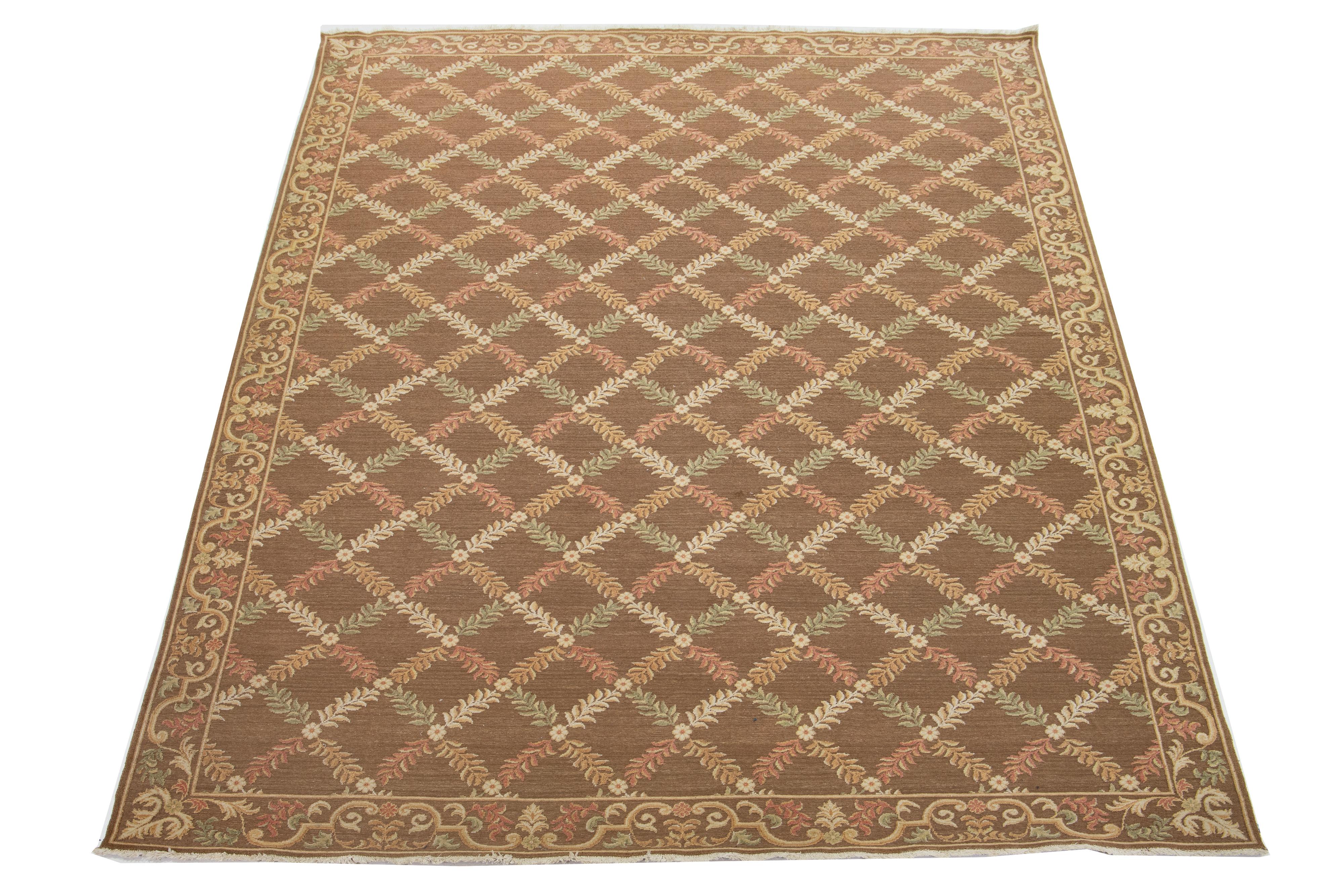 This is a beautiful transitional-style Basserabian hand-knotted wool rug with a brown field. Its frame features goldenrod, green, and rust accents in a gorgeous French floral pattern.

This rug measures 10'2