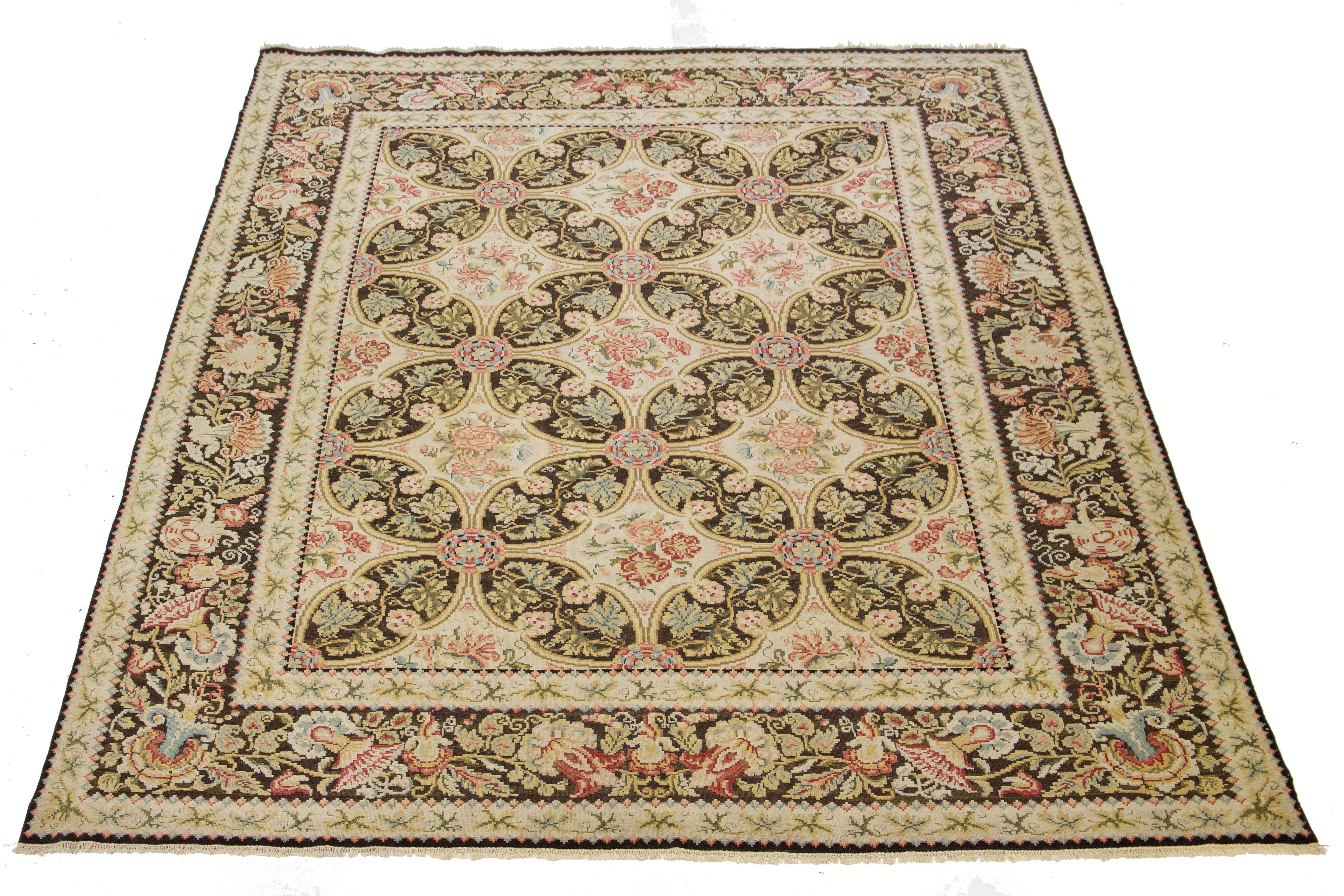 This is a beautiful antique-style Basserabian hand-knotted wool rug with a beige field. It has a designed brown frame and multicolor accents in a gorgeous French floral pattern.

This rug measures 12' x 15'6''.
