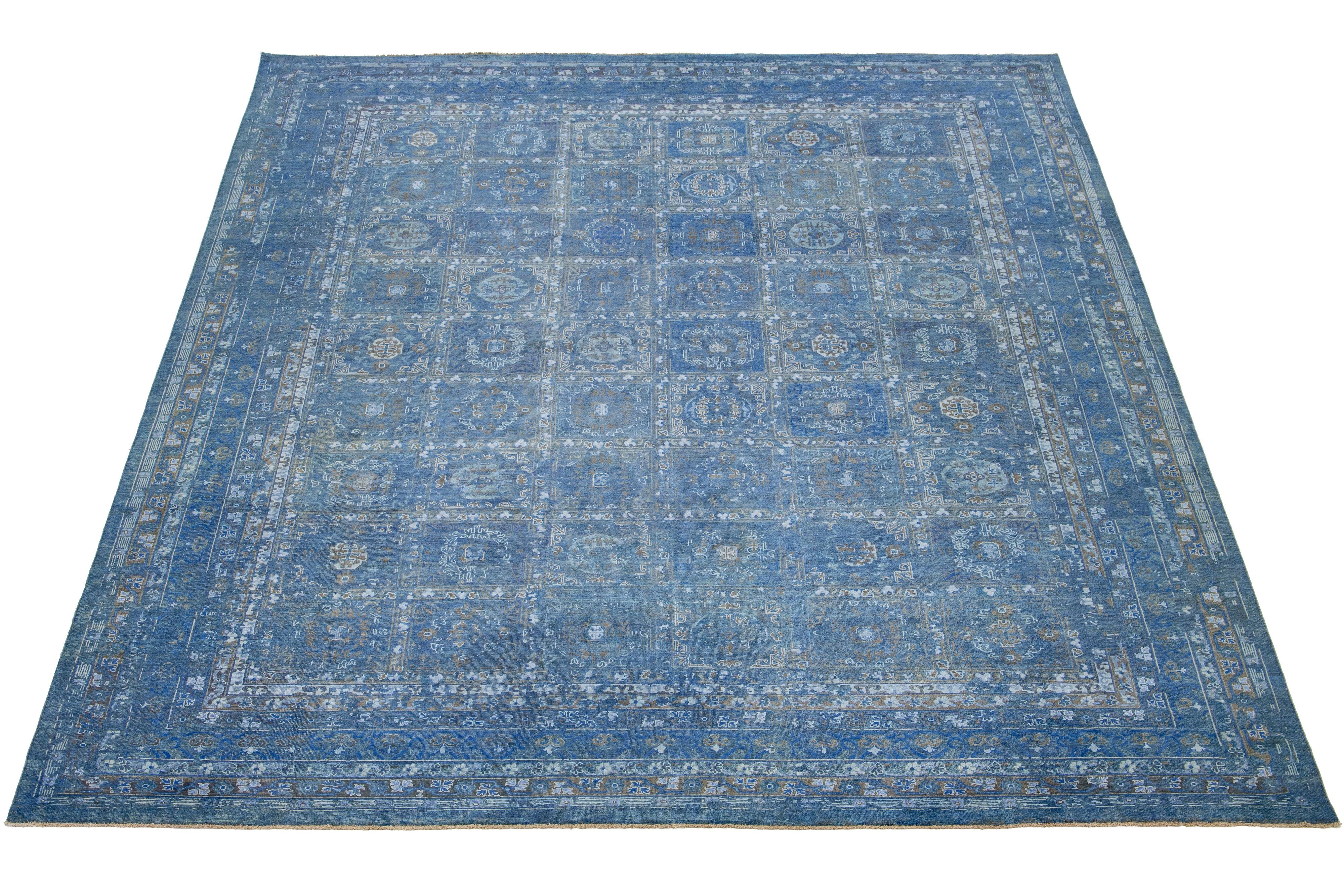 Crafted from hand-knotted wool, this exquisite rug showcases a stunning blue backdrop with an elegant all-over floral design. The addition of ivory and brown accents brings a touch of Transitional charm to its overall look.

This rug measures 11'10