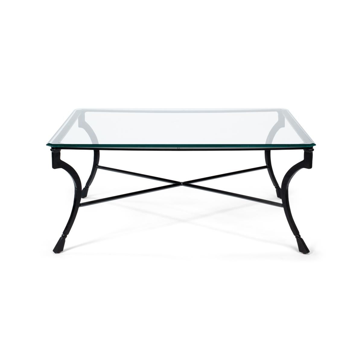 With a thick beveled edge glass top on an iron base with a classic form on curved legs and an x-form stretcher.

Dimensions: 48