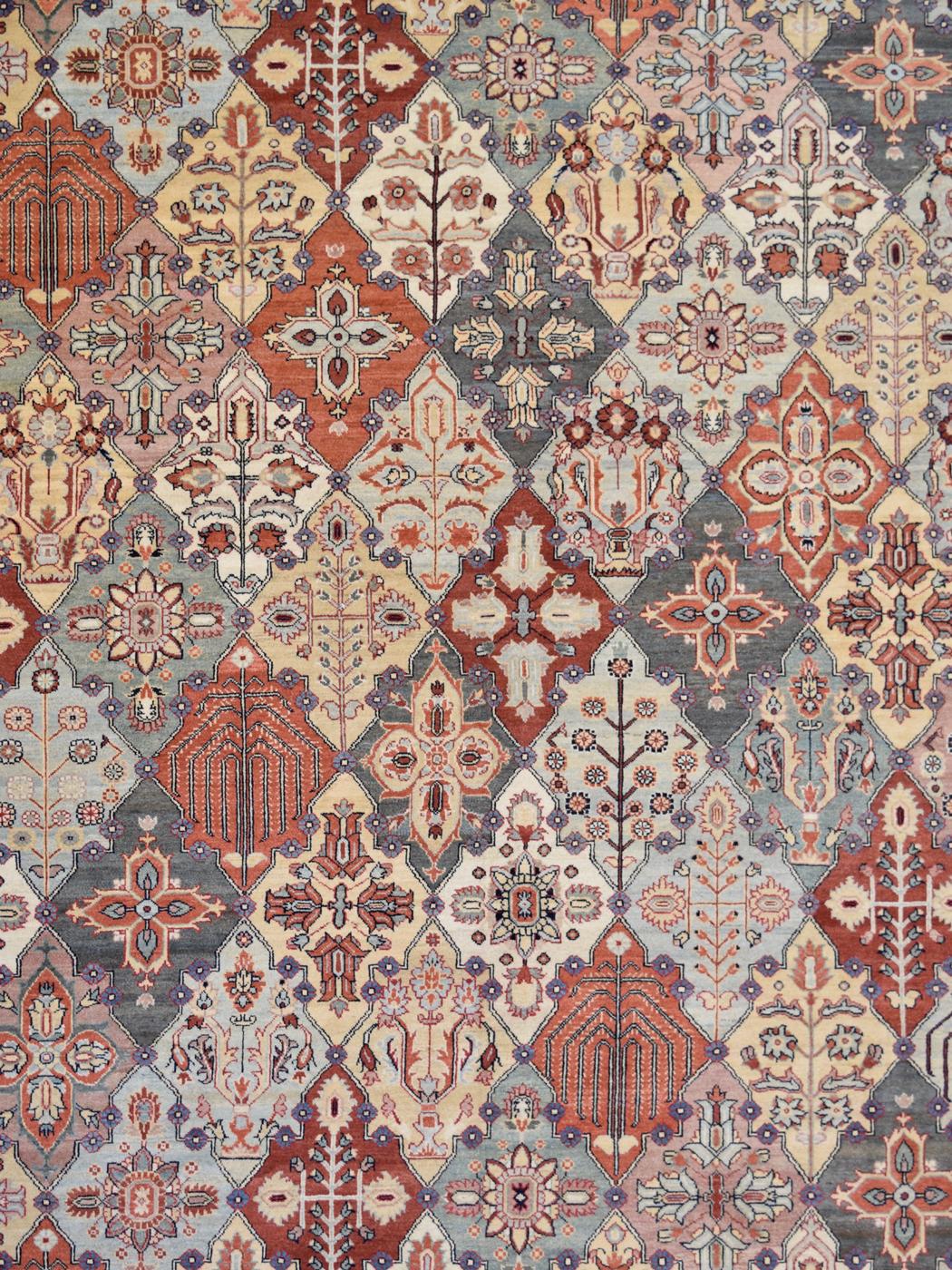 In warm and inviting hues of cream, soft blue, orange, red, gold, and indigo, this hand-knotted carpet features a classic Persian Bakhtiari design and belongs to the Orley Shabahang Transitional Collection. Measuring 9’10” x 13’8”, this carpet