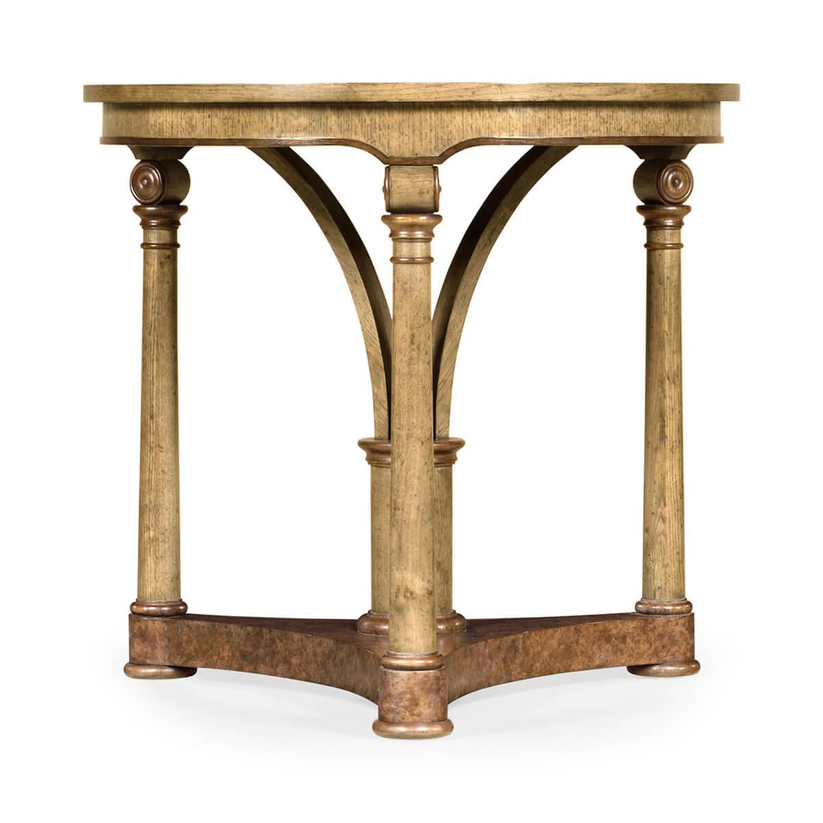 Transitional English light brown oak round side table with both a central pedestal and three leg supports raised on a tripartite base.

Dimensions: 28