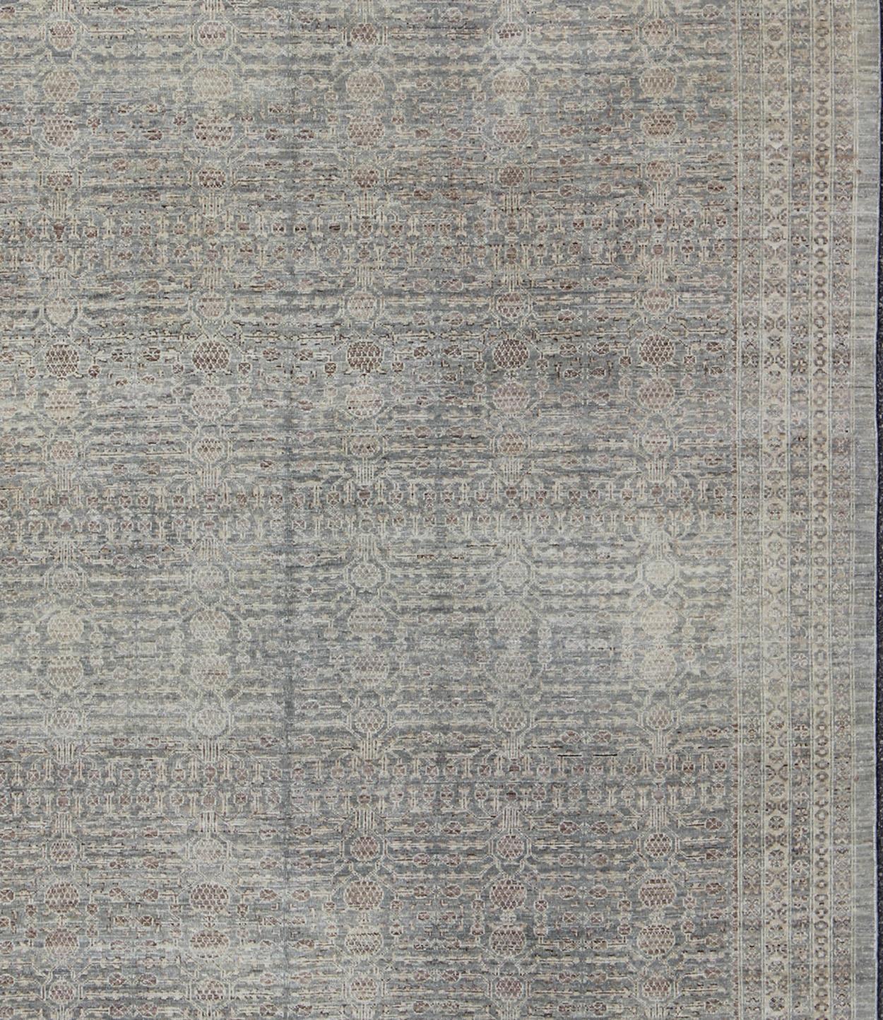 Light gray/green background Khotan rug in Pomegranate Design with light and medium Brown highlights and taupe, rug KOL-69236 country of origin / type: Afghanistan / Khotan

This transitional Khotan features all-over pomegranate design flanked by a