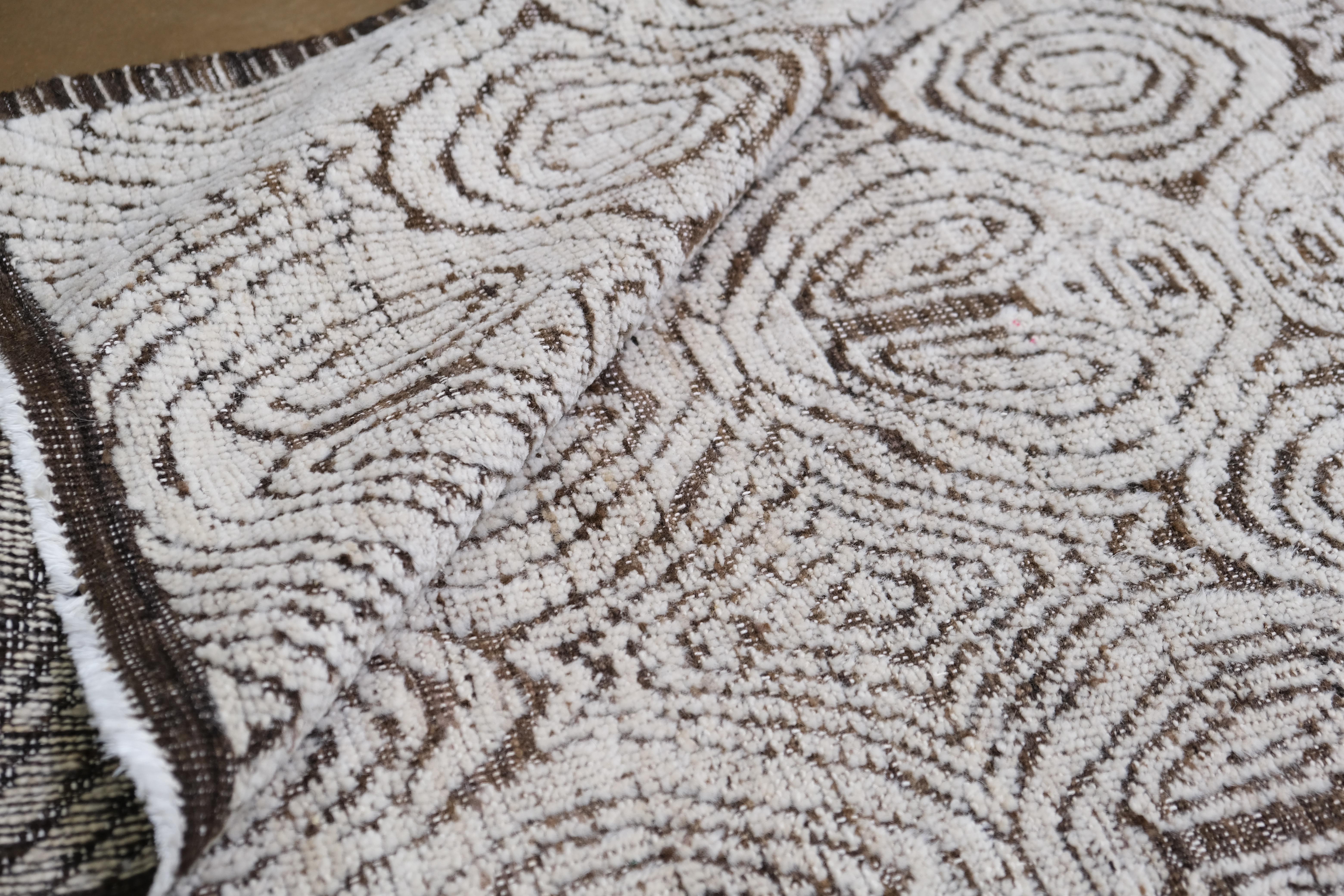 Dieser atemberaubende, handgeknüpfte Wollteppich zeichnet sich durch ein faszinierendes und kompliziertes Design aus, das sowohl handwerkliches Können als auch moderne Raffinesse widerspiegelt. Mit den beeindruckenden Maßen von 12'2