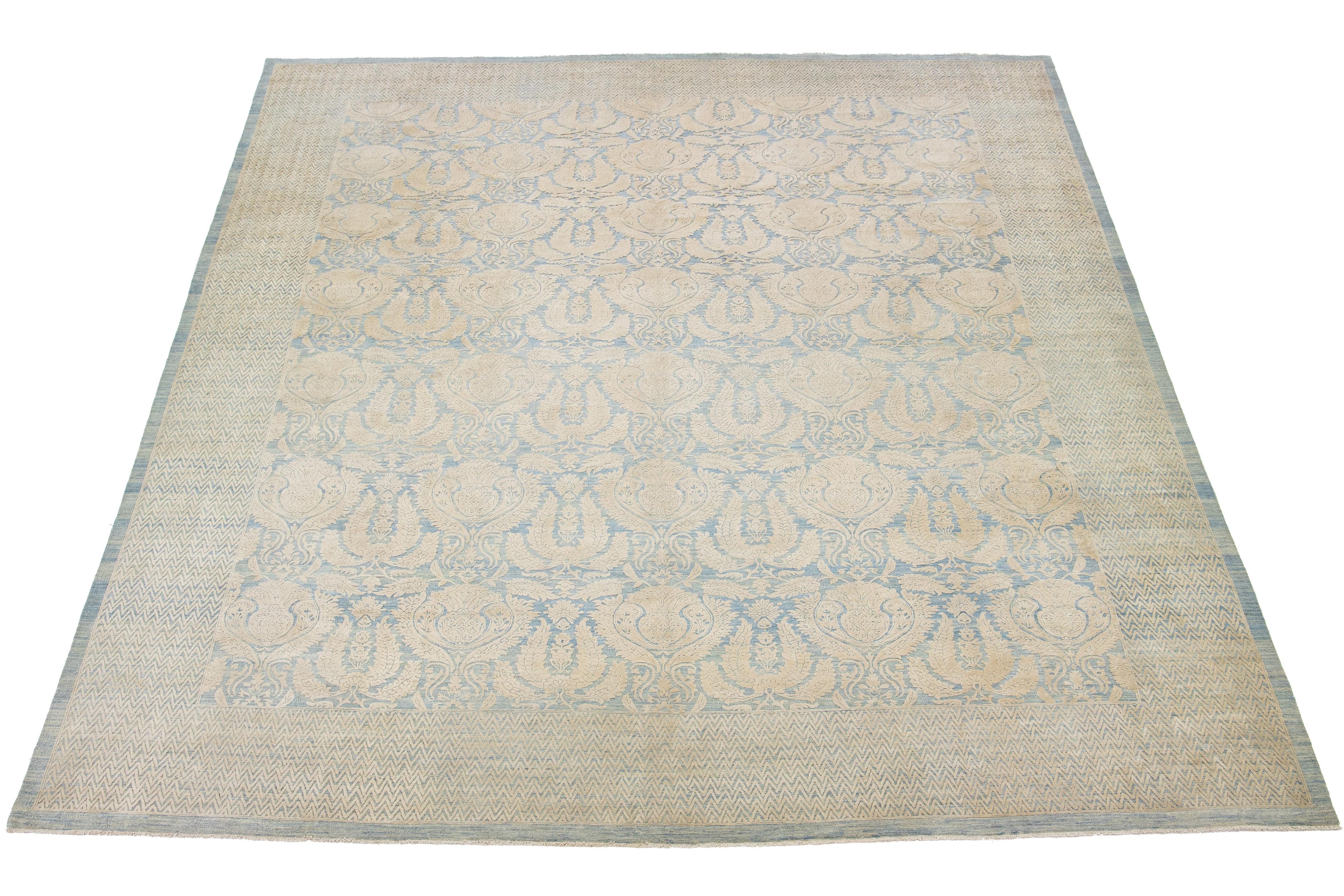 This hand-knotted wool rug showcases a blue field. It's designed with a stunning allover floral pattern and accented with beige hues in a Transitional allure.

This rug measures 11'9
