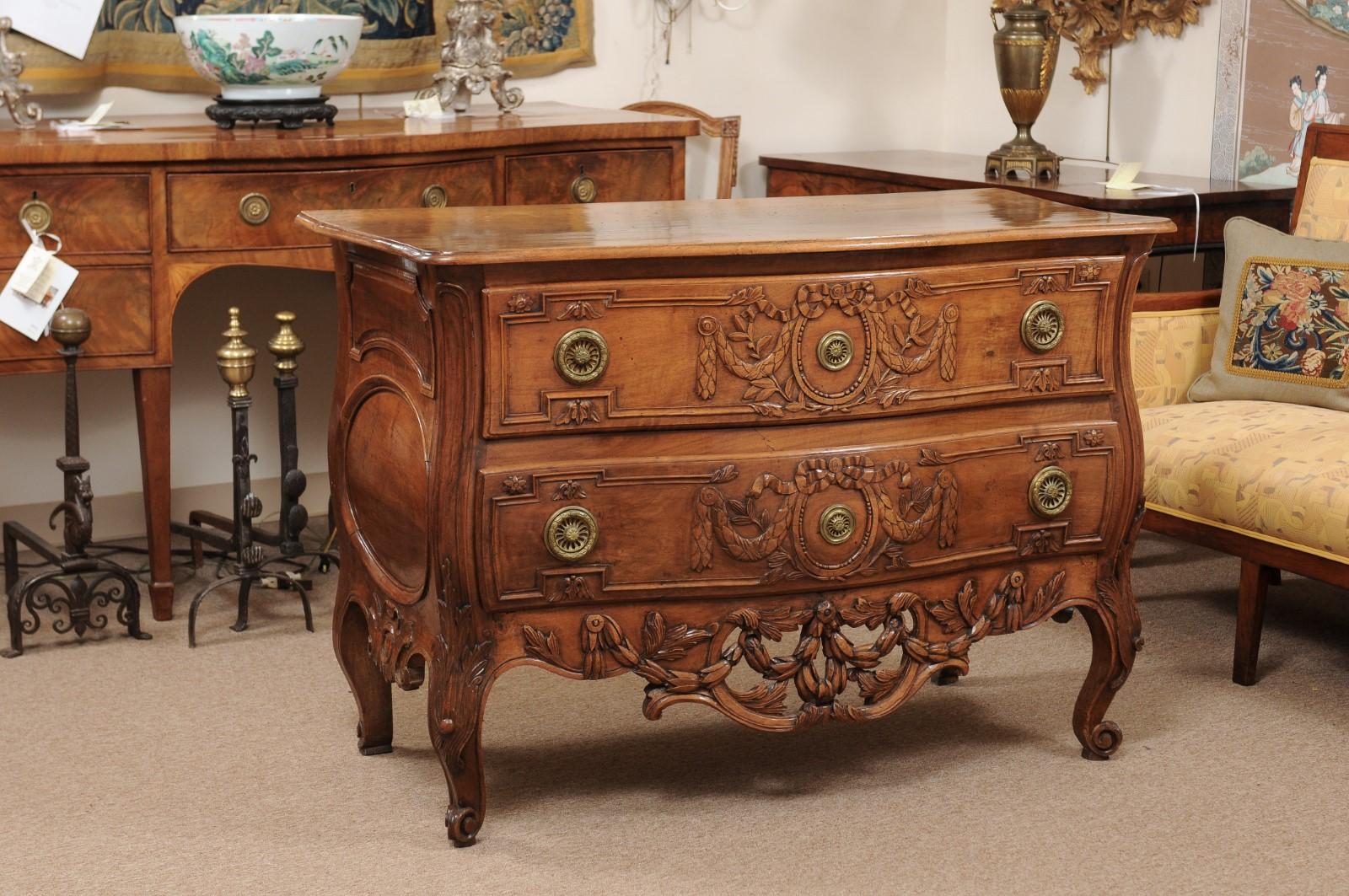 18th century French Transitional Louis XV/XVI 2-drawer commode in walnut with pierced apron and cabriole legs.