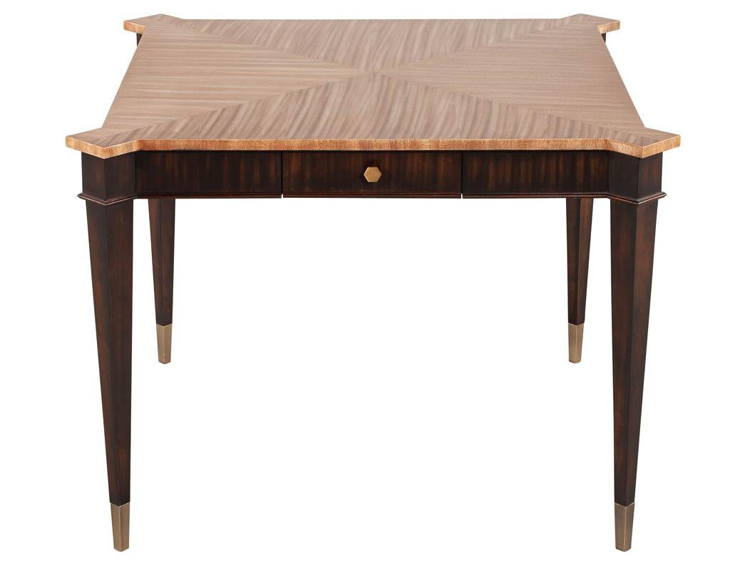 Transitional mahogany games table in 2 tone natural finish. Beautiful natural satin finished top with rich walnut colored legs. Completed with 4 felted drawers and brass accented hardware. A great piece for games night or breakfast nooks.

Price
