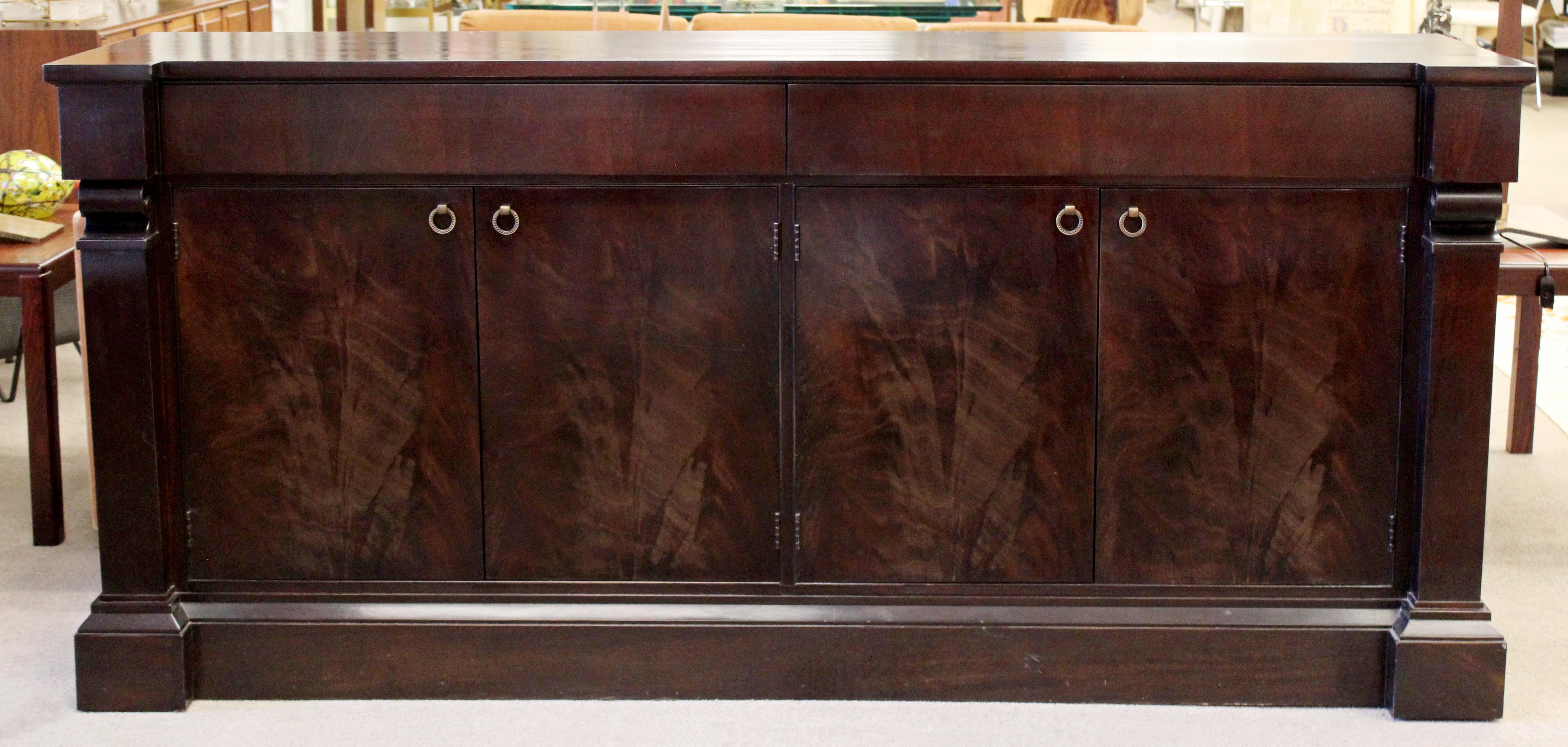 For your consideration is a captivating and large, carved mahogany, transitional style credenza, by Baker Furniture, circa 1980s. In excellent vintage condition. The dimensions are 79.5
