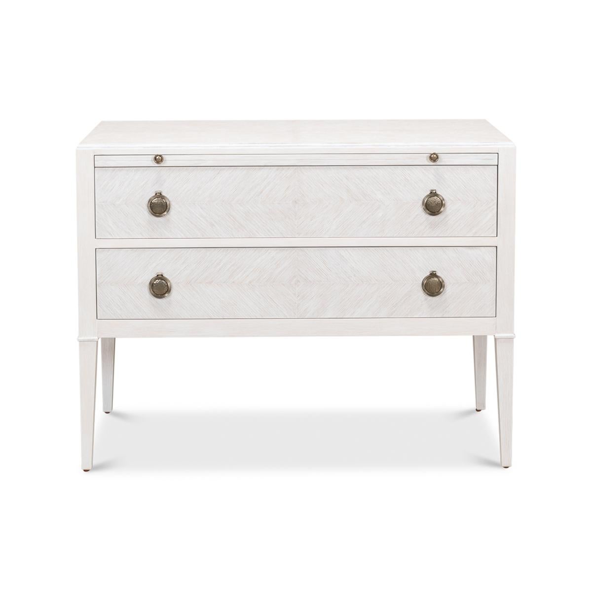 In the French Louis XVI style, the Transitional Painted Oak Dresser has a herringbone pattern in a white wash finish, with a long dressing slide above two long drawers, with brass hardware and raised on square tapered legs. 

Dimensions: 38