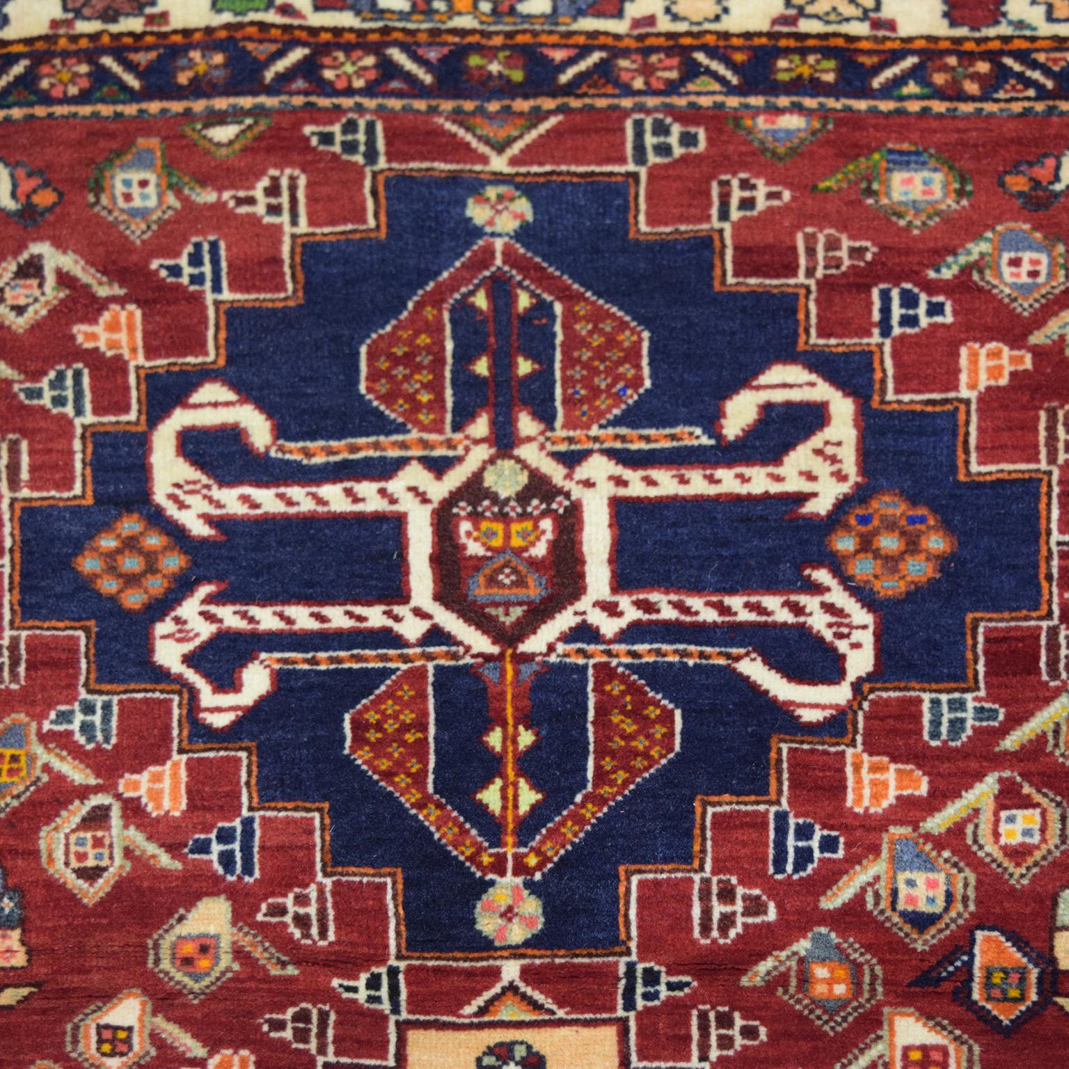 Measuring 3’7” x 5’7”, this transitional red, blue, and cream Persian Kashkouli wool carpet is hand-knotted and belongs to the Orley Shabahang World Market Collection. Because this carpet utilizes a traditional Persian weaving technique, this carpet