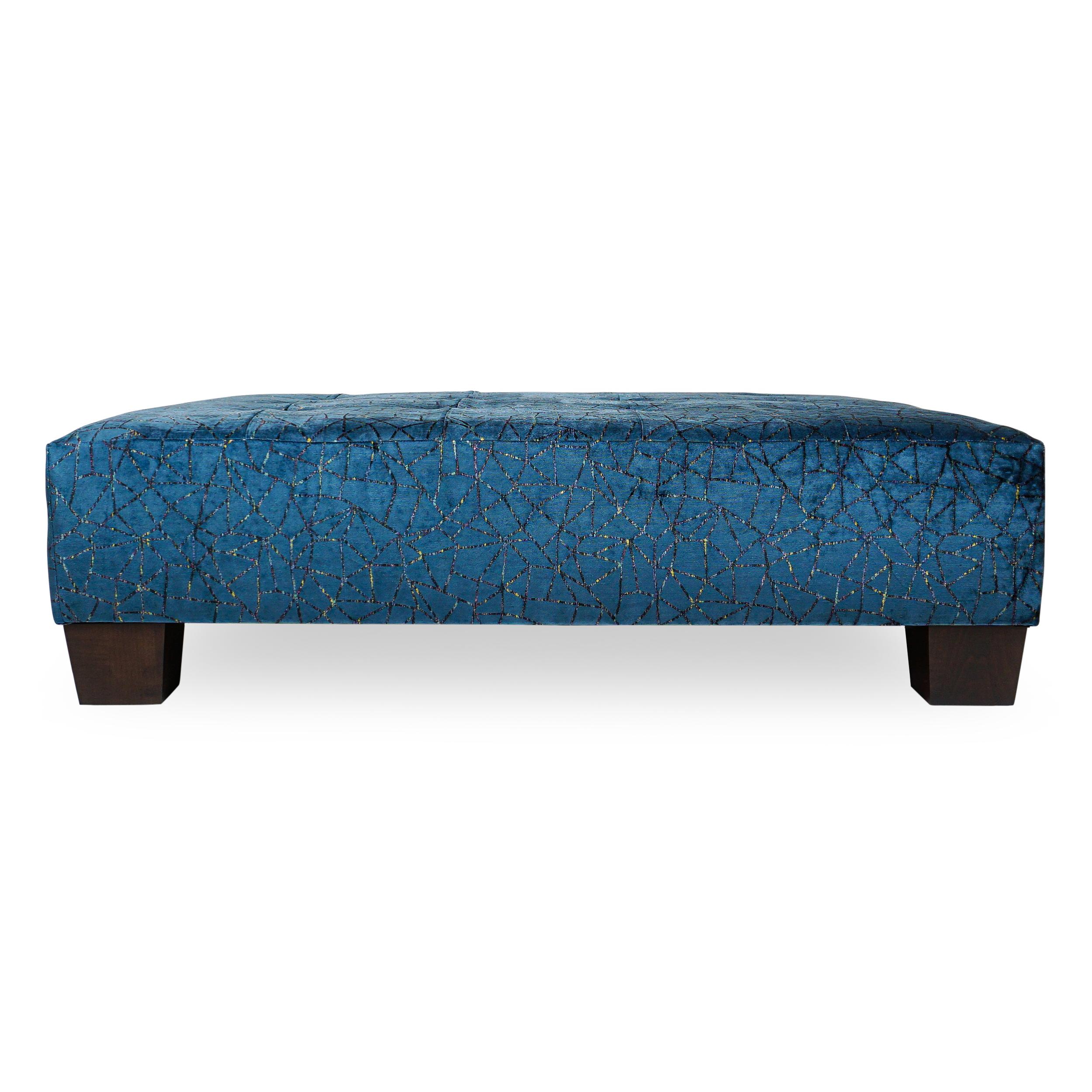 Transitional tufted ottoman in a modern shimmering blue cut velvet with metallic detail and thick stained maple feet. Frame made with solid hardwood and upholstered with eight-way hand-tied springs and high density foam. Firm enough to hold a tray