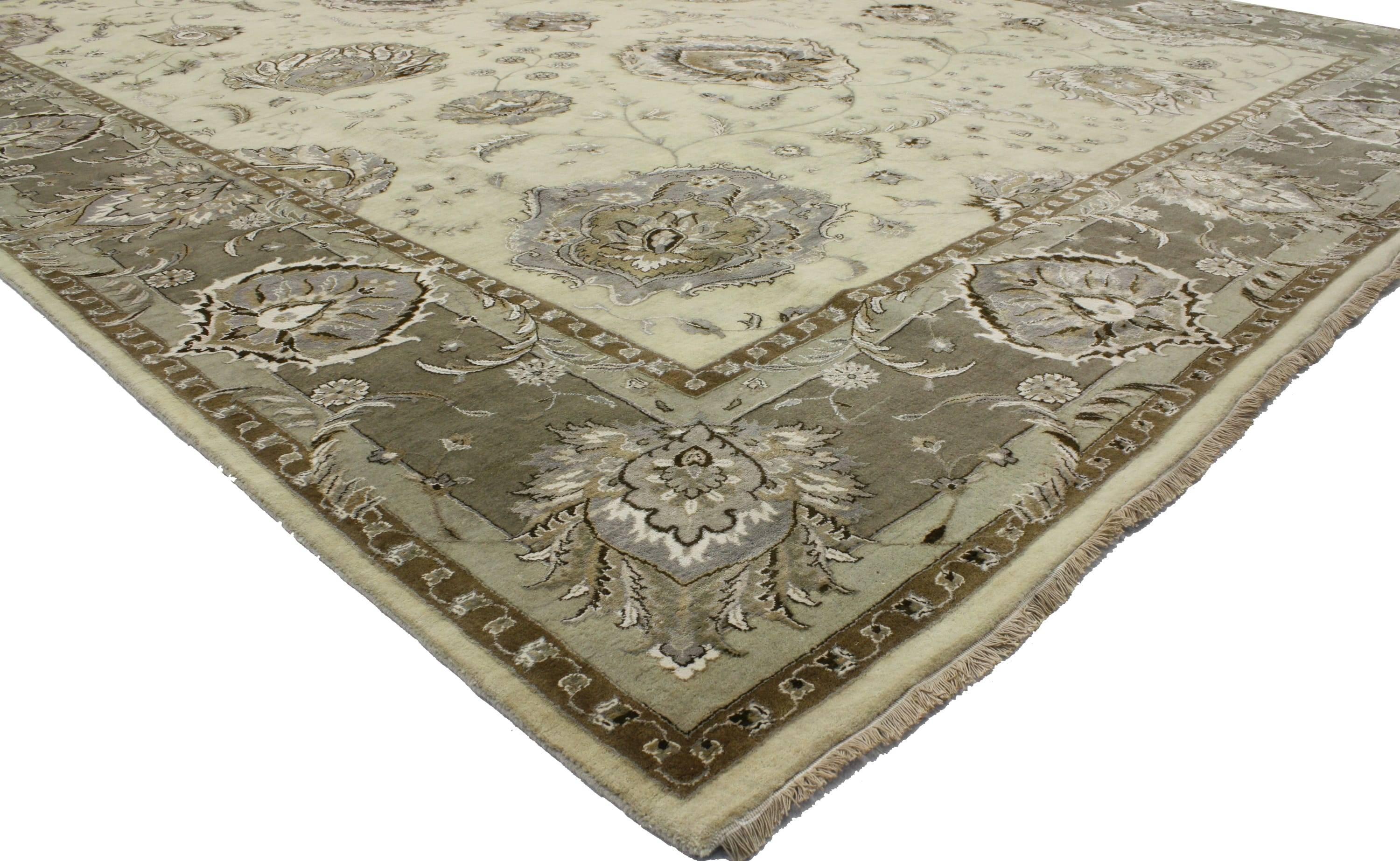 30237 New Transitional style area rug with Oushak design and neutral colors. This hand knotted wool transitional Indian rug features an all-over floral arabesque pattern spread across an abrashed field. Large palmettes, scrolling vines, blossoms,