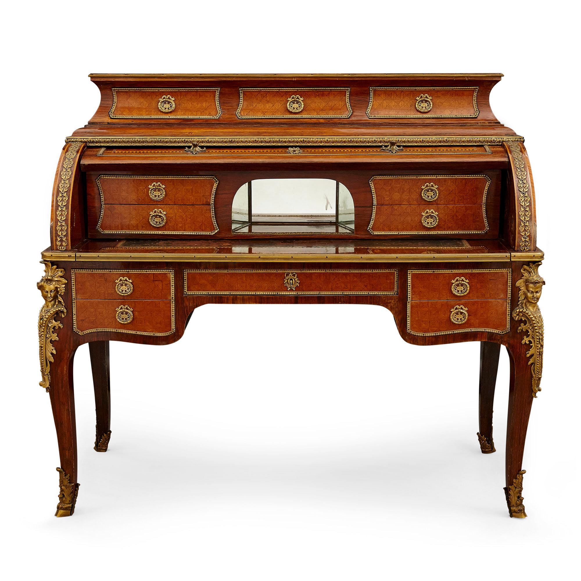Transitional style gilt bronze mounted roll top bureau
French, 19th century
Measures: Height 121cm, width 135cm, depth 59cm

This fine roll top bureau is of traditional form and demonstrates the best of the Transitional style. The desk features