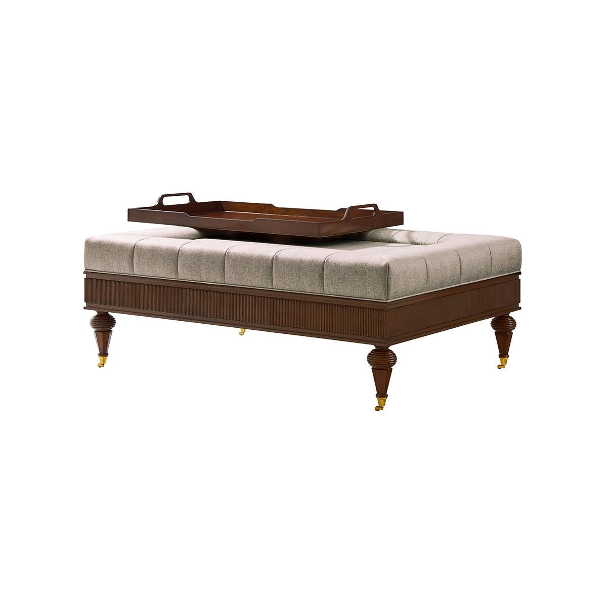 With Anglo-Indian antecedents – and a go-to for today’s home. The channel-upholstered top is paired with a handy removable tray, and set in a reeded panel base. Finished with octagonal tapered legs with capitals and brass castors.

Dimensions: 50