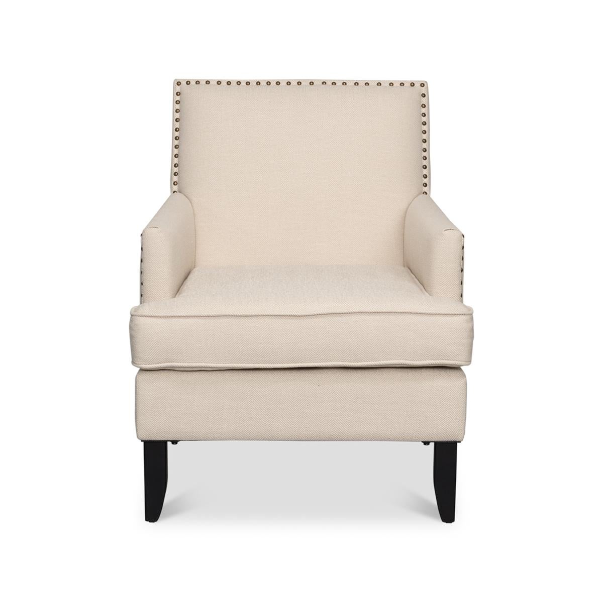 Transitional Upholstered Armchair, with a solid maple ebonized frame and ivory linen fabric, with an upholstered cushion backrest and seat cushion having large brass nailhead detailing.

Dimensions: 27