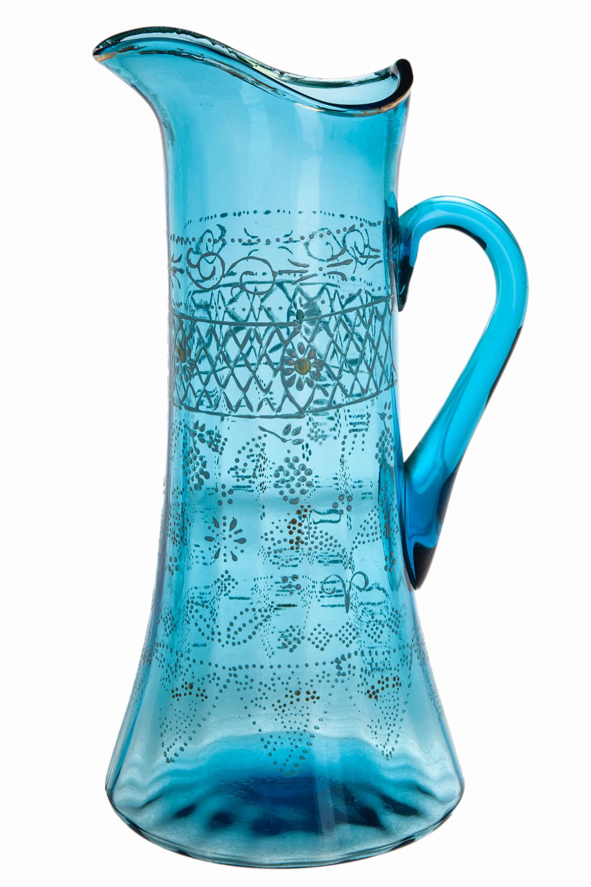 Late 19th C/early 20th C brilliant translucent aqua blue hand blown glass pitcher w/ applied handle. Gilt rim & accents hand painted in enamel with intricate patterns throughout.