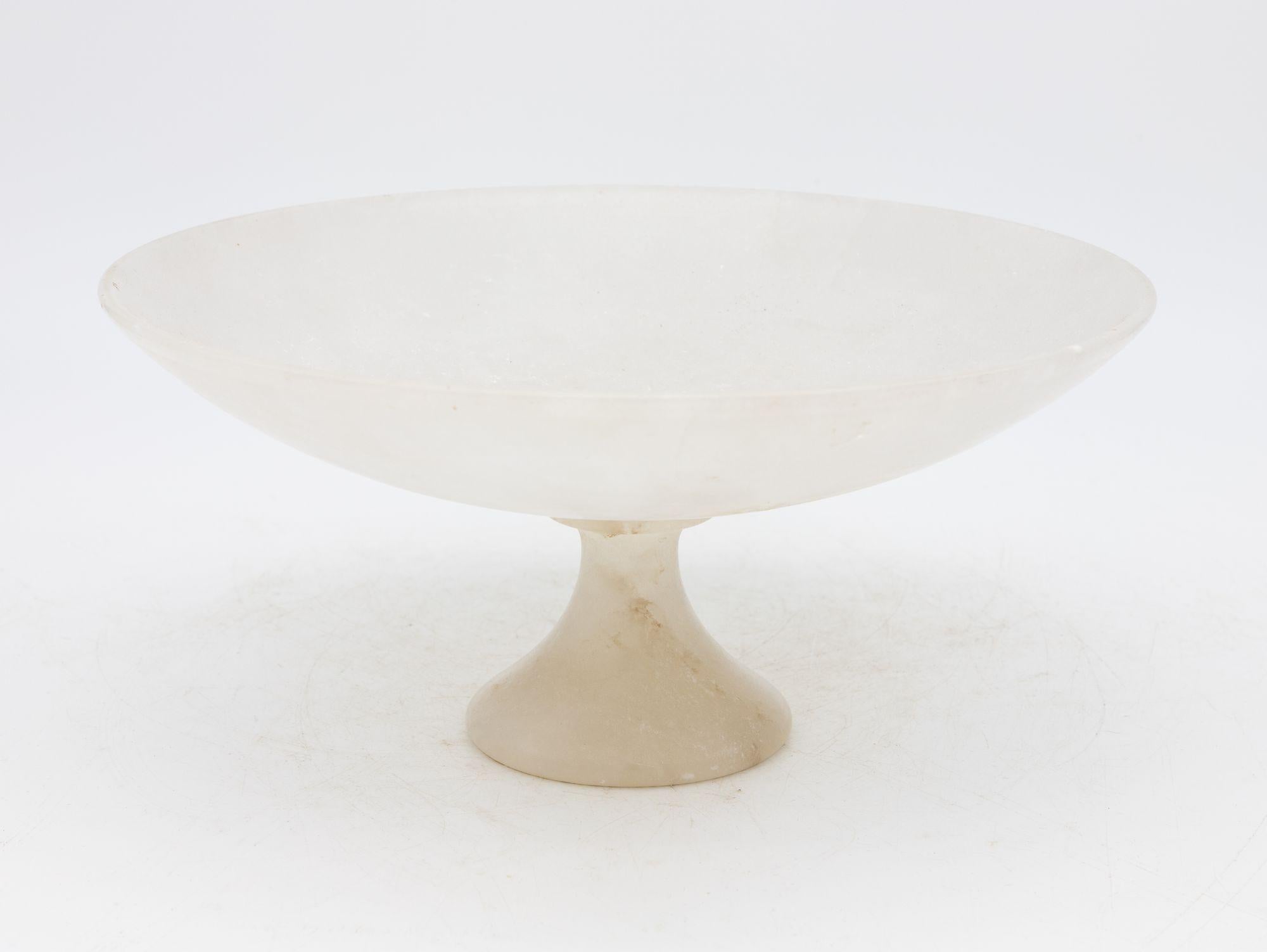 This early 20th-century Italian Neoclassical style alabaster compote or bowl exudes timeless elegance with its translucent beauty. Refined craftsmanship stands as a testament to the artistry of its era. The wear, consistent with its age and use,