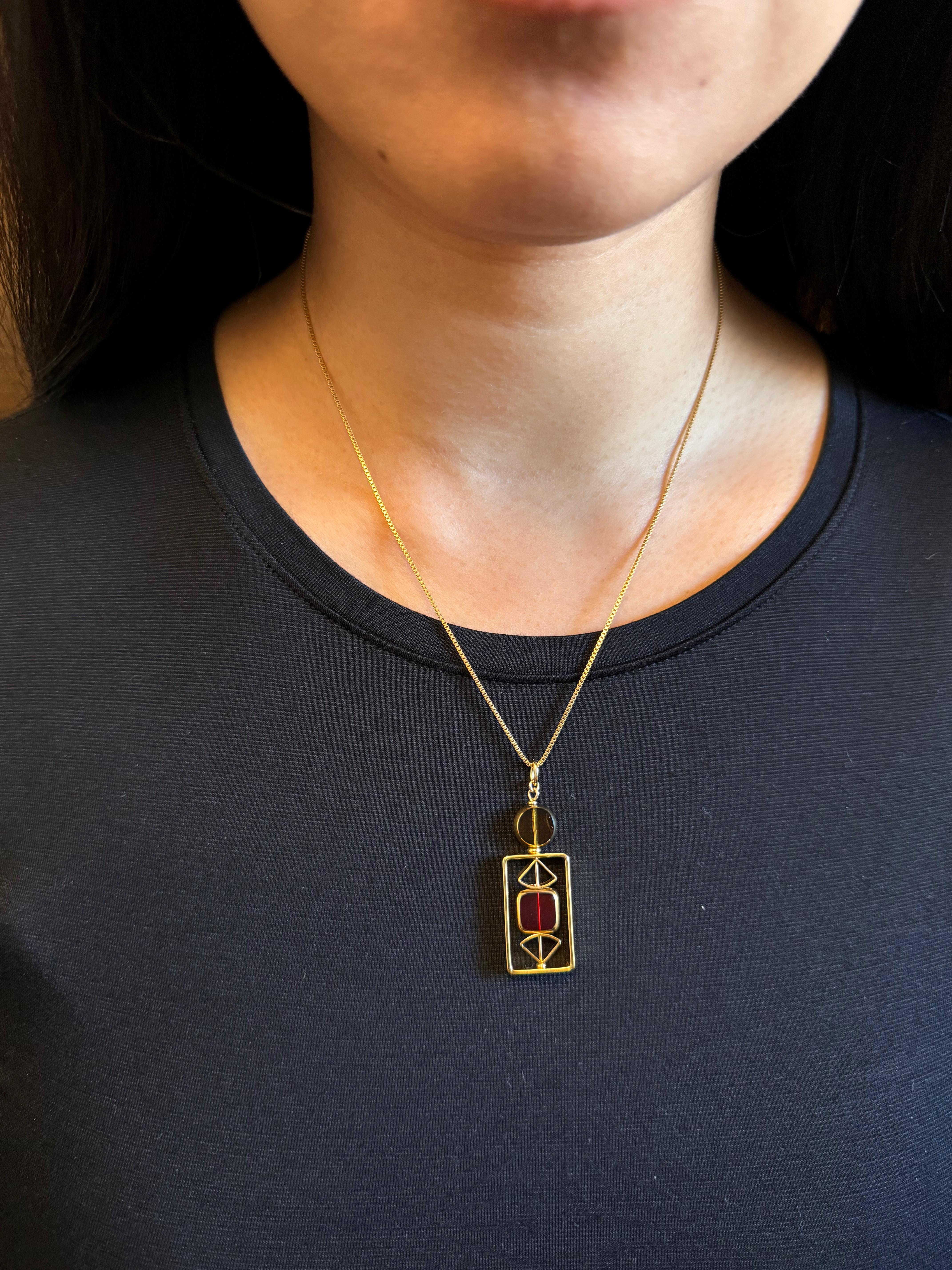 The pendant consists of translucent yellow and red vintage German glass beads and is finished with an 18-inch gold-filled chain. 

The beads are new old stock vintage German glass beads that are framed with 24K gold. The beads were hand-pressed