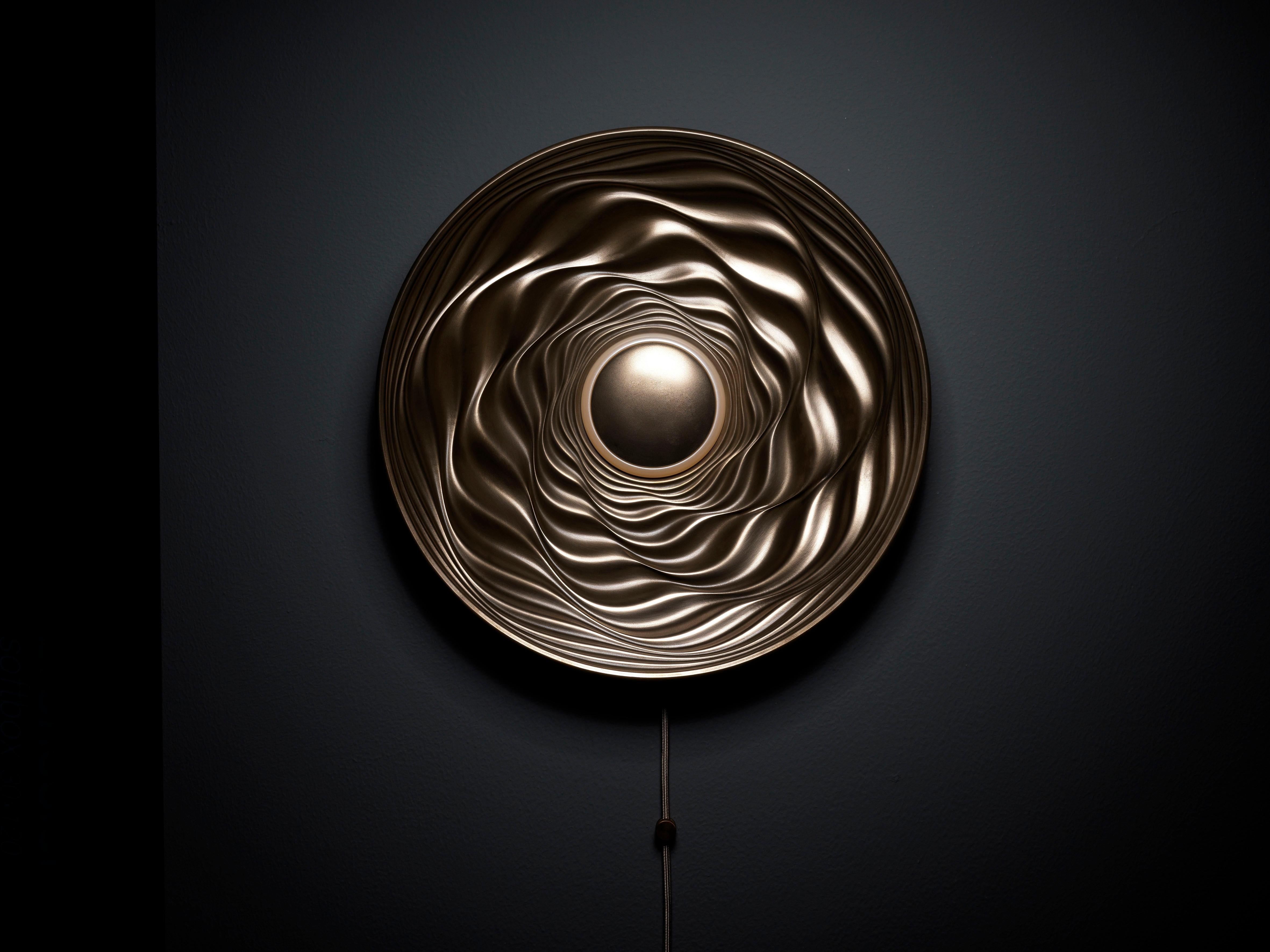 Transmission is limited edition, illuminated wall mounted sculpture which creates different effects depending on the use of its integral lighting, external illumination or both.

By day, the piece has a distinctive character where surface
