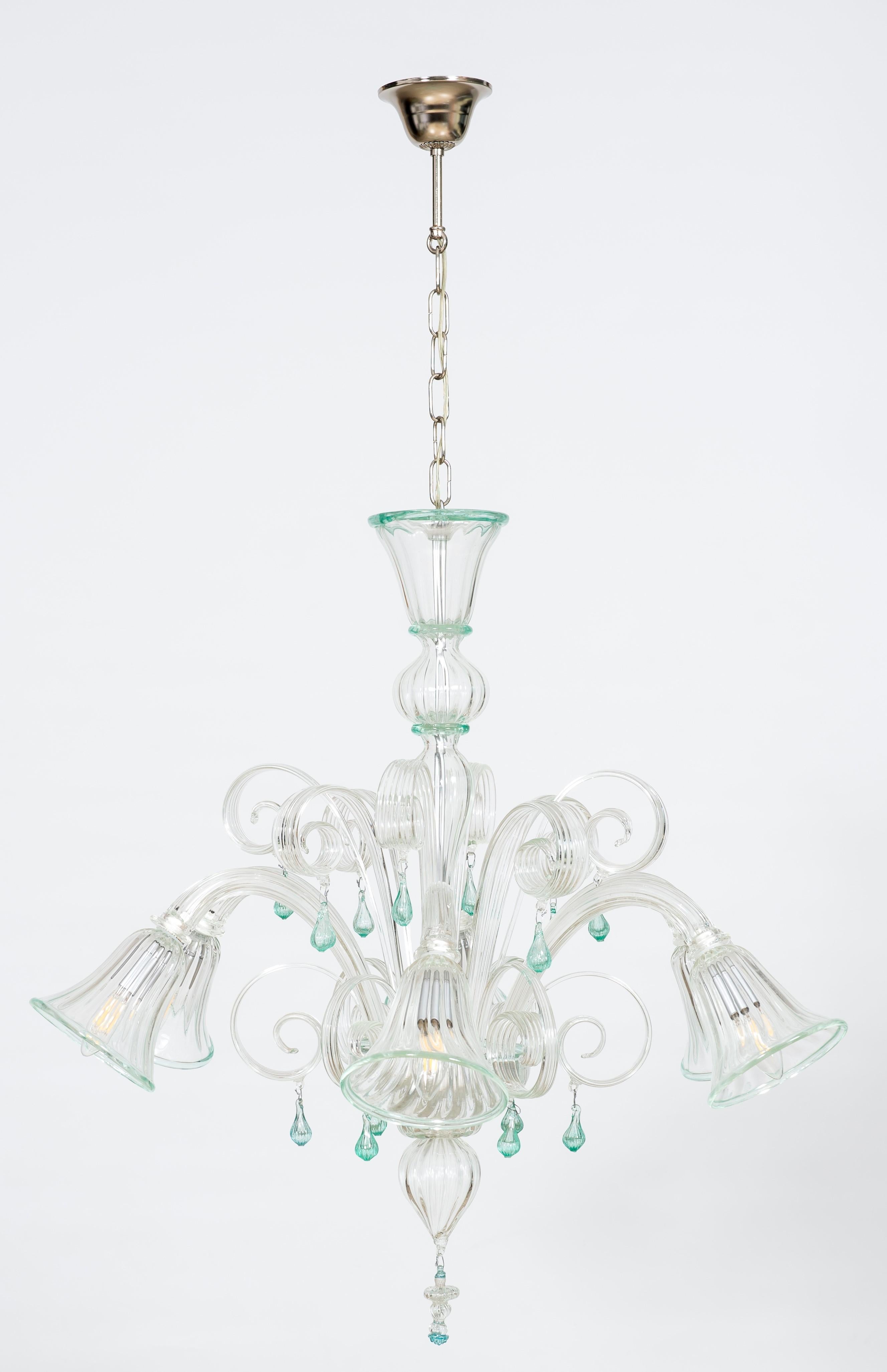 Transparent and Green Bluebell Chandelier in Murano Glass, Italy.
This superb glass art chandelier was entirely made in the Venetian island of Murano with transparent glass and water-green finishing.
6 lights are enclosed by beautiful