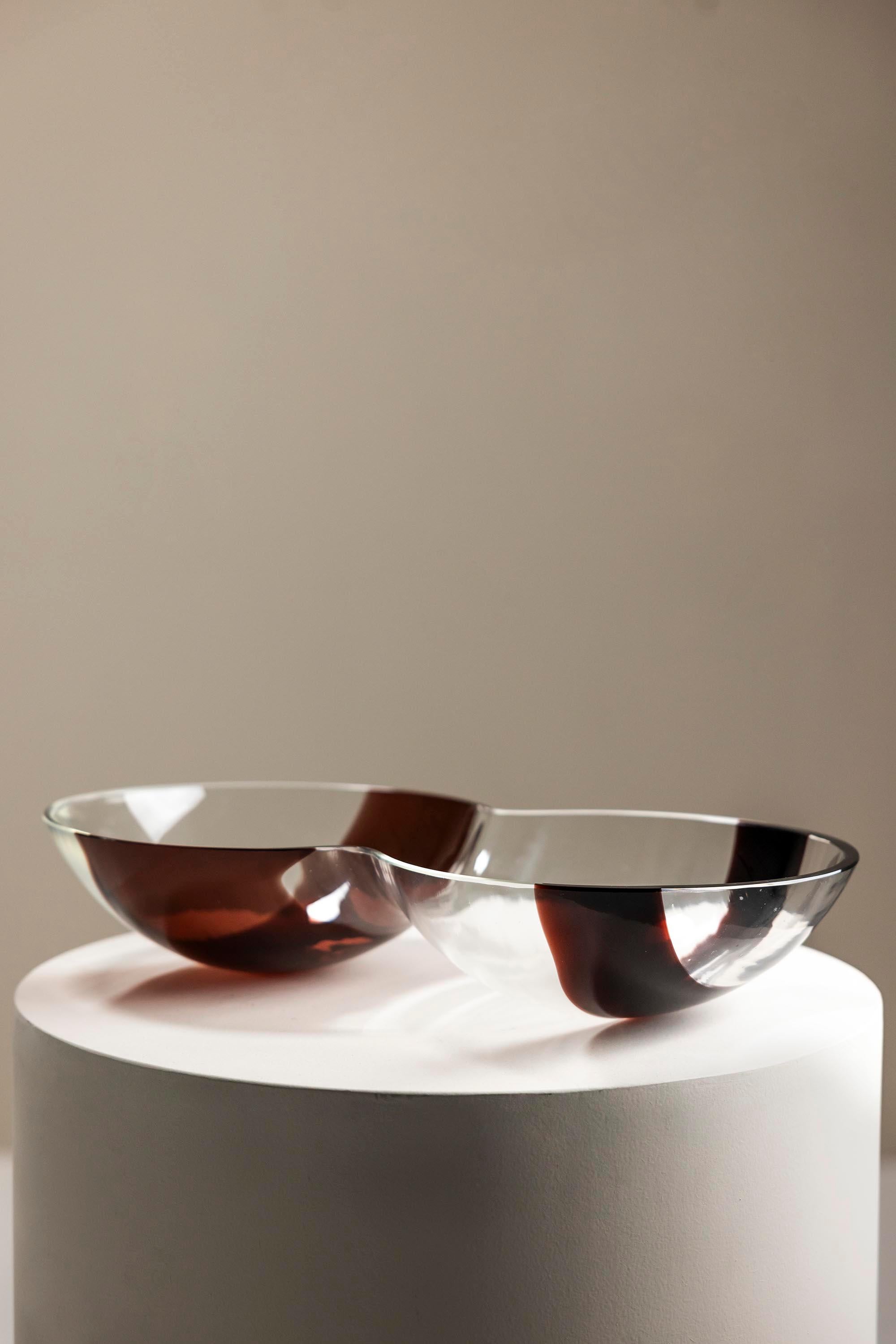 Step into the serene world of Mazzega, where craftsmanship meets creativity. This Carlo Nason glass centerpiece bowl is a harmonious blend of form and function. Its sleek contours draw the eye, while two brown bands add a touch of earthy elegance.
