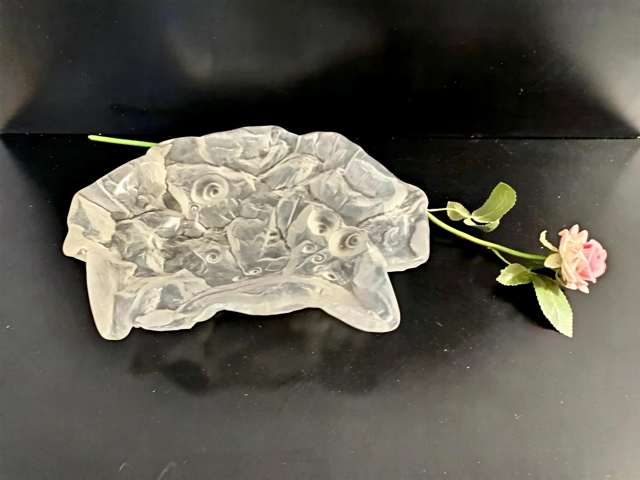 Made in Italy, 1970s.
It is made in quite heavy 4-layered iridescent cornflower blue and white hand-blown glass. 
This trinket bowl / ashtray looks like a fossil. It is polished inside and has a matte etched finish outside.  
This is a vintage