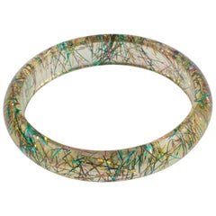 Bracelet jonc transparent en lucite avec inclusions de fils métalliques multicolores