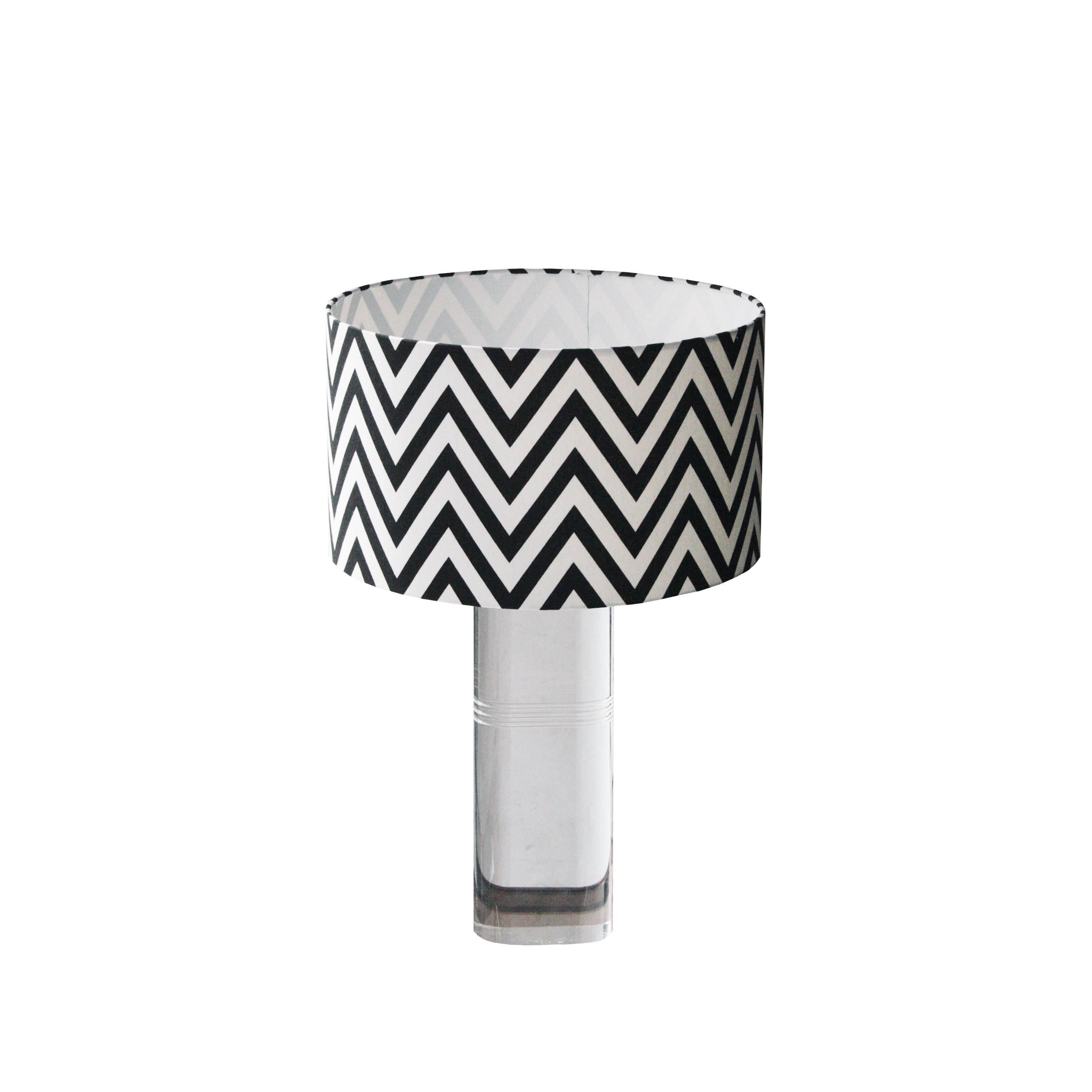 Pair of transparent methacrylate lamps with brass details and handmade lampshade in black and white zig zag.