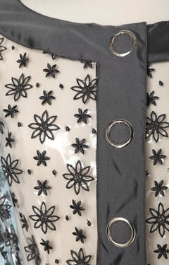 Transparent plastic jacket with grey Moschino embroidery