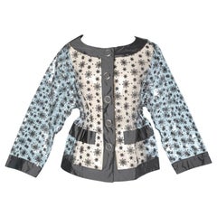 Transparent plastic jacket with grey Moschino embroidery