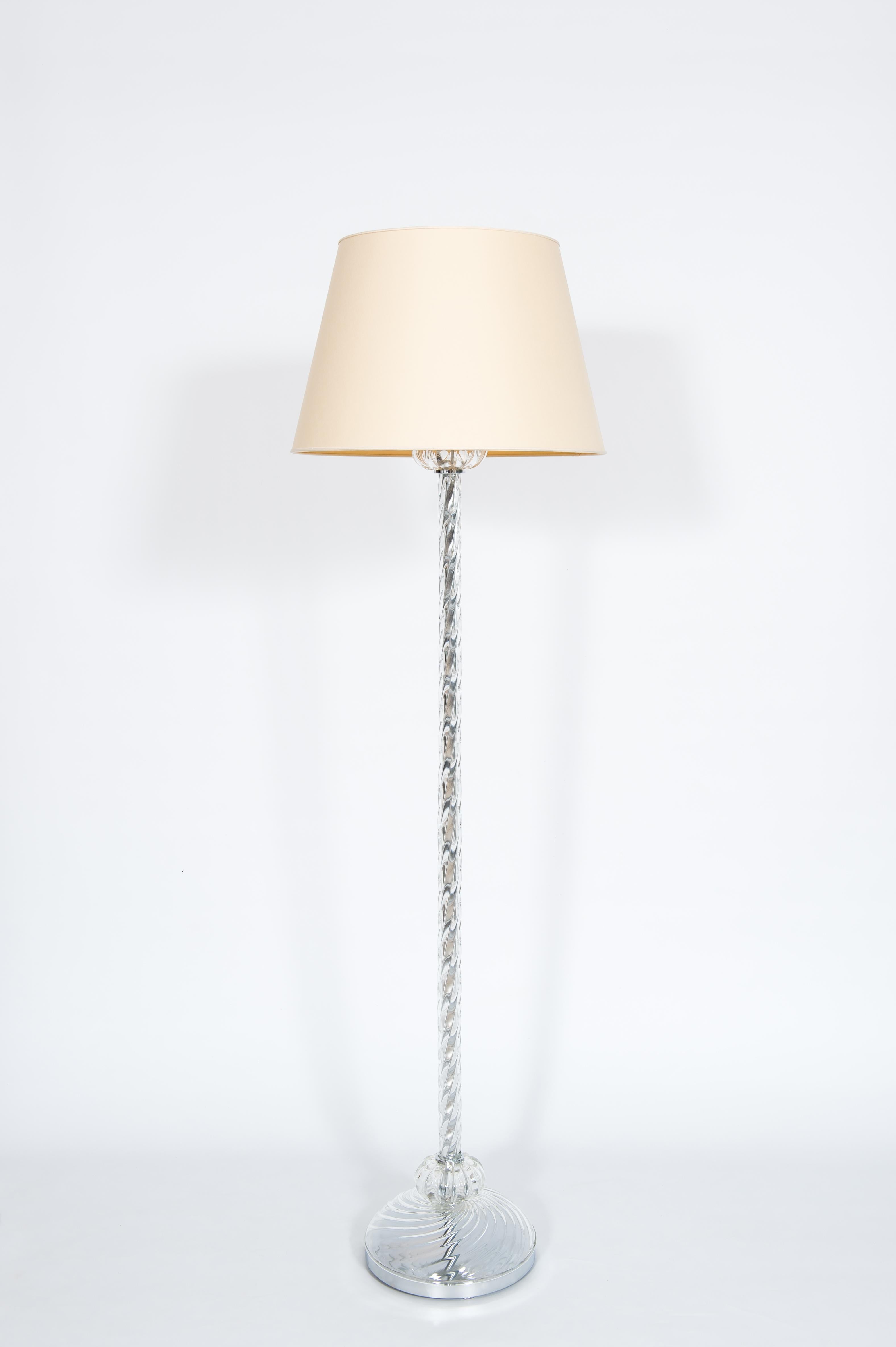 Transparent Torchon floor lamp in blown Murano glass, Contemporary, Venice.

This floor lamp is an outstanding masterpiece of the world-famous Murano glass art. 
The base is made of a chromed round base topped by a transparent glass cup. On top