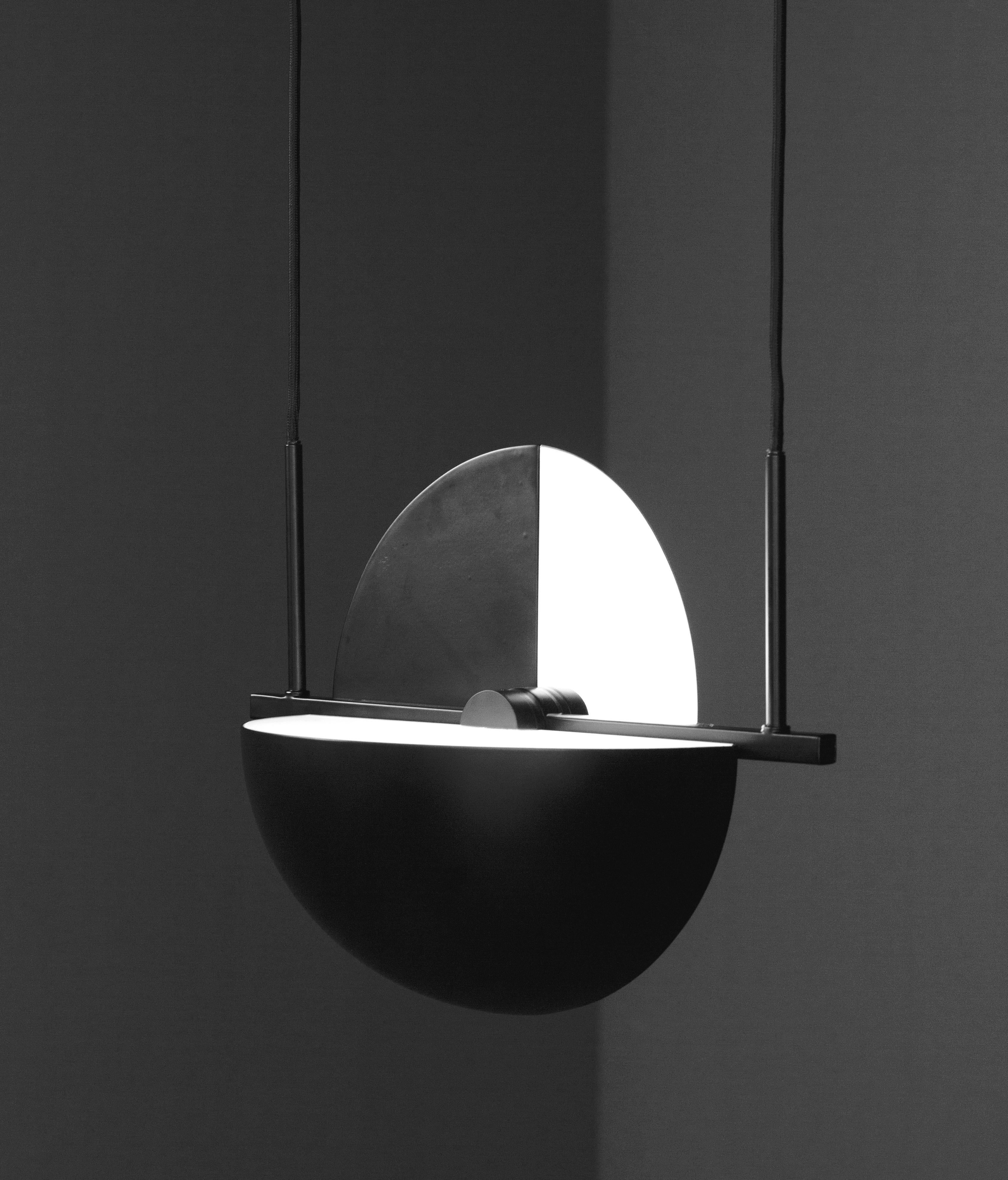 Trapeze pendant by Jette Scheib
Dimensions: 37.5 x 28 x 28 cm (Ø) (cord length: 300 cm)
A chrome version is also available.

Trapeze is as much a single pendant as it is an endless system of possibilities. The square tube has a build in