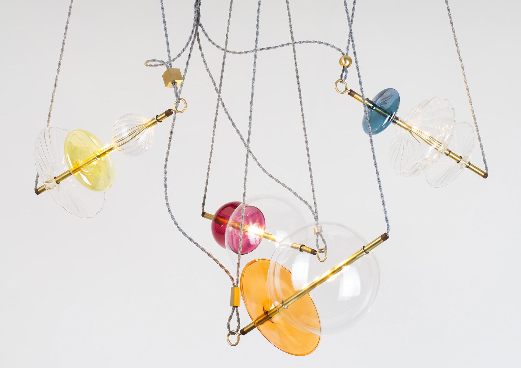 The Trapezi is a single edition, one of a kind pendant light or chandelier, inspired by the idea of a Circus Trapeze Artist. This unusual light pendant composition reinterprets in a totally different way the classic Murano chandelier