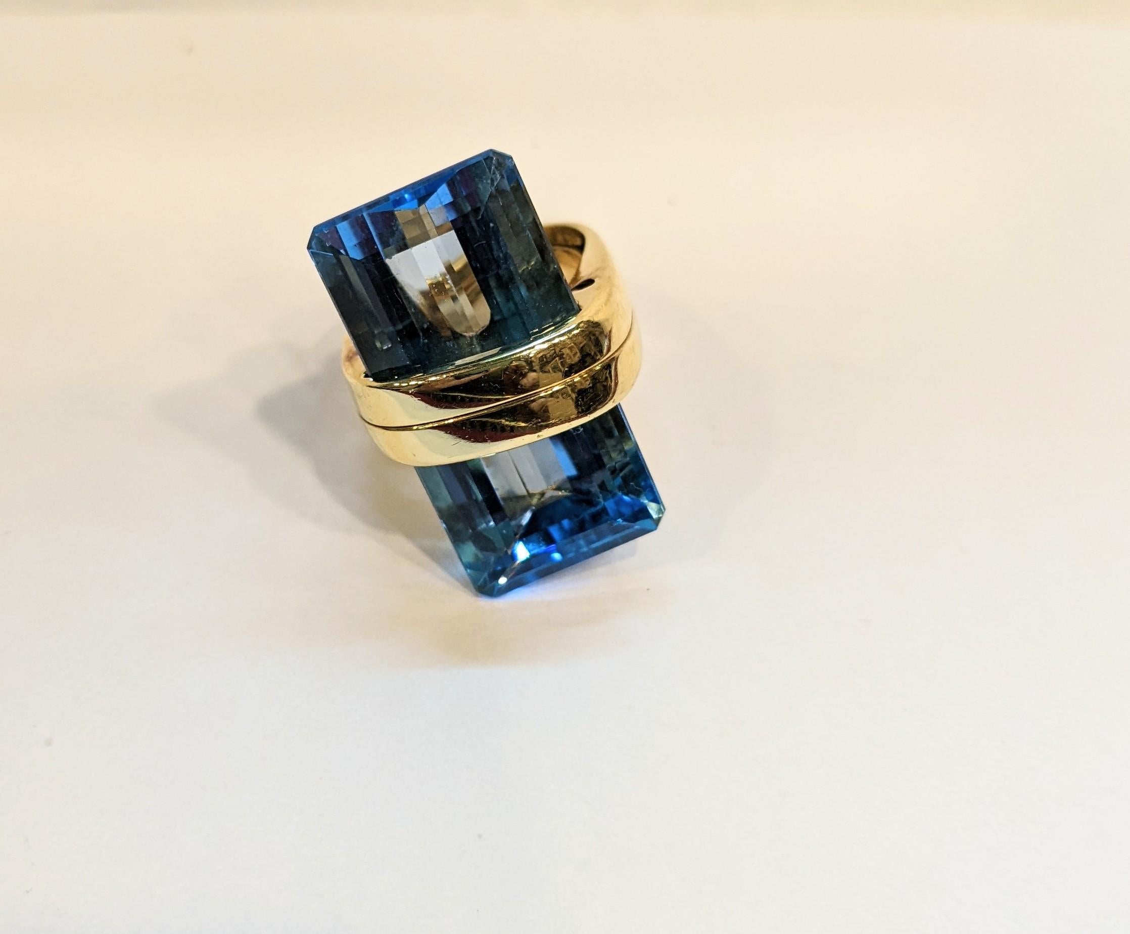 Ring 18K Yellow Gold with Trapezoid Shape Blue Topaz 12ct
Total Weight 35 gr.
Size Ring with adaptor starting Europe size 52 

PRADERA is a  second generation of a family run business jewelers of reference in Spain, with a large track record  being