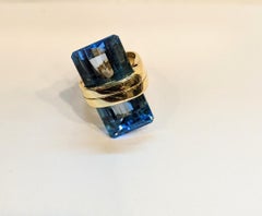 Trapezoid cut blue topaz 18k gold cocktail ring
