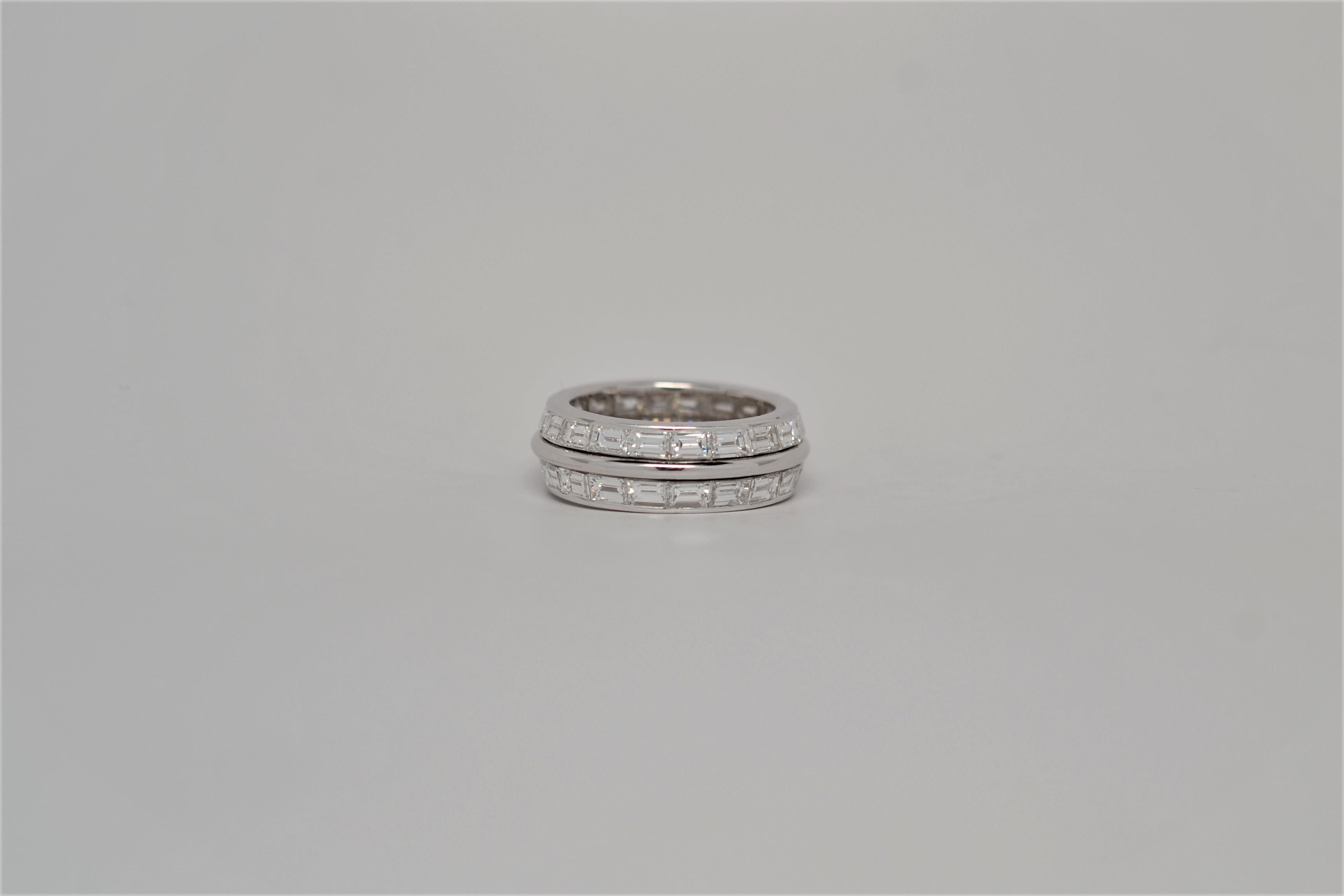 A finely made 18K White Gold Eternity Ring set with Trapezoid Cut Diamonds. The two row eternity ring layout is channel set in an East - West pattern with forty Trapezoid Cut Diamonds that weigh 5.92ct. Diamond color grade range F to G and clarity