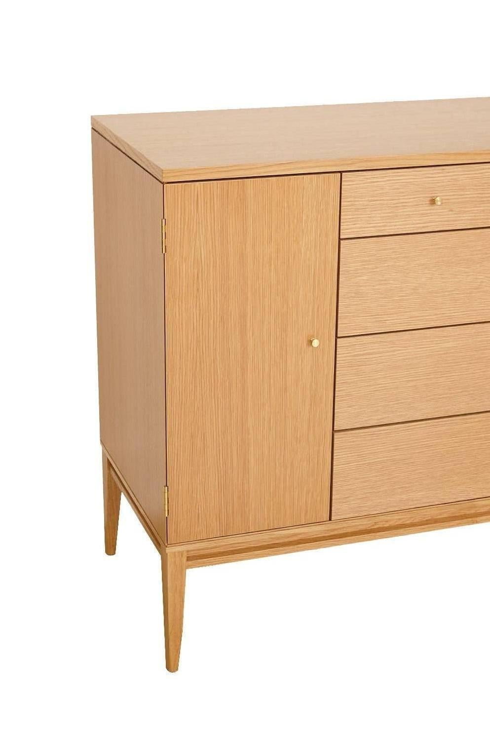Trapp white rift oak 20-drawer dresser. Dresser features ten exterior drawers with ten interior small drawers behind left and right side doors. Fun dovetail joinery and solid brass hardware throughout.