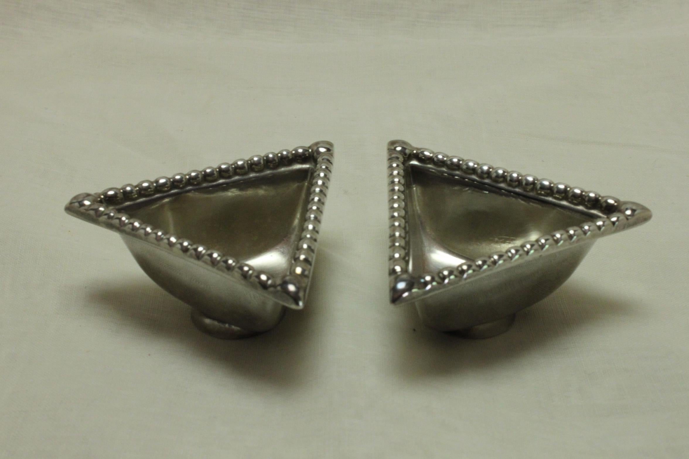 This boxed set of Traprain Law replica sterling silver salts and spoons was made by Brook and Son of Edinburgh in 1929. The triangular salts feature beaded moulding to the rim and stand on a circular foot. They measure 75 mm (3 inches) along each