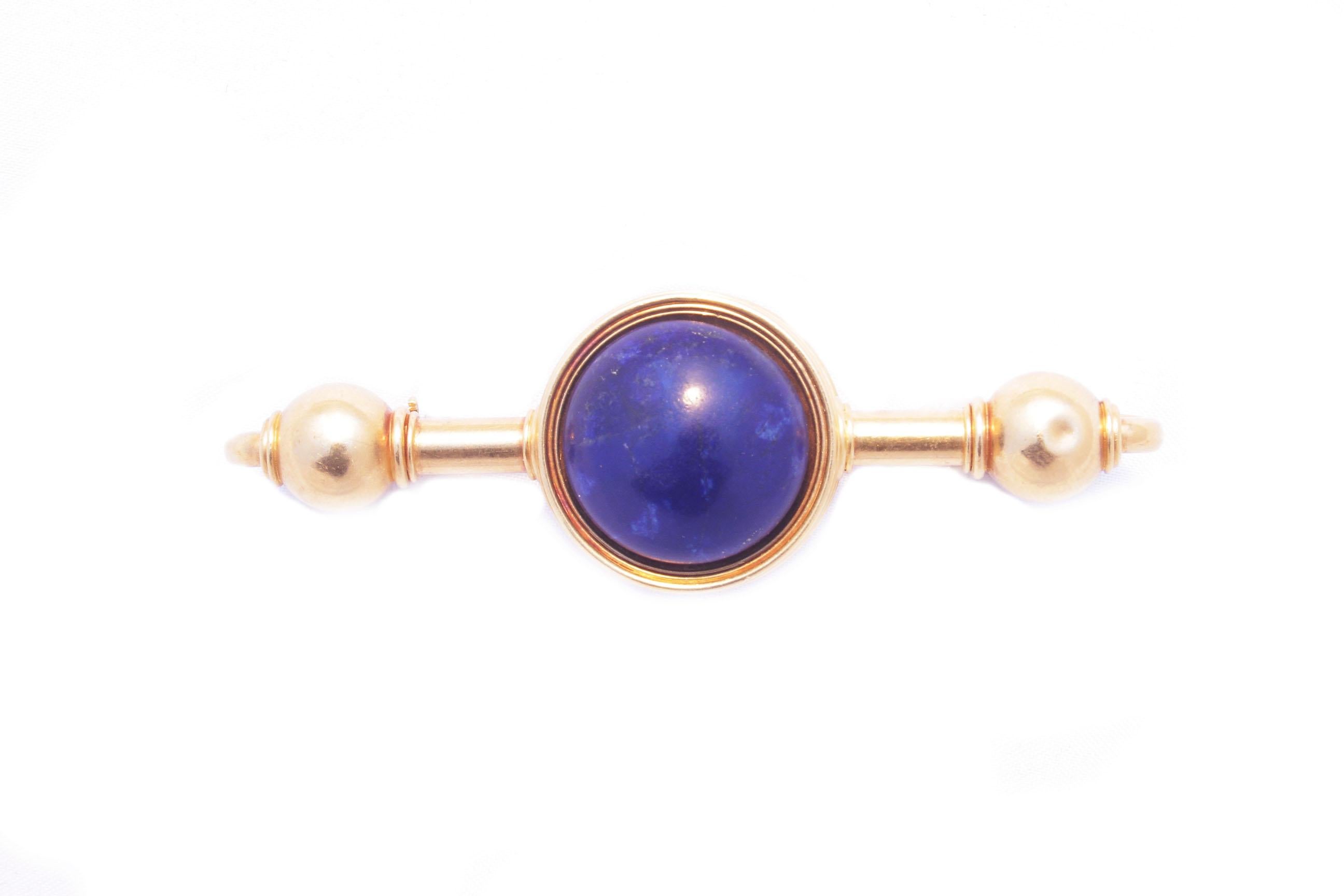 A beautiful antique brooch, manufactured by the historic Roman jeweller Travaglini, embellished by a large spherical lapis-lazuli element on a polished yellow gold mounting typical of the time, marked “ROMA”. Hallmarked Travaglini, mid 19th century.