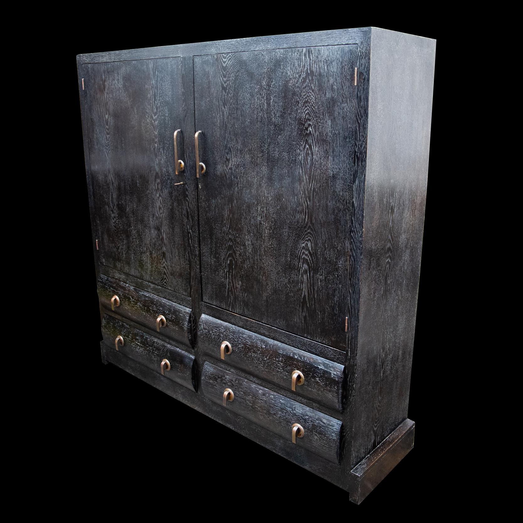 An important beautifully made brushed oak cabinet with superb original and unusual bronze ornamentation with inlaid faux tortoiseshell. Almost certainly a commissioned unique piece of the period. The top main section comprised of two large lockable