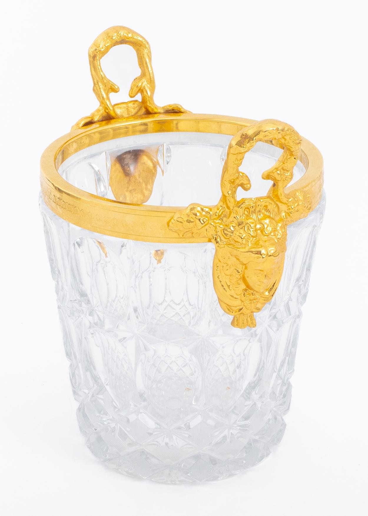 A cut crystal champagne bucket with gilded brass rim. Made by designer Travail Francais in the 1990s. Piece is very heavy.

Dealer: R316TF.