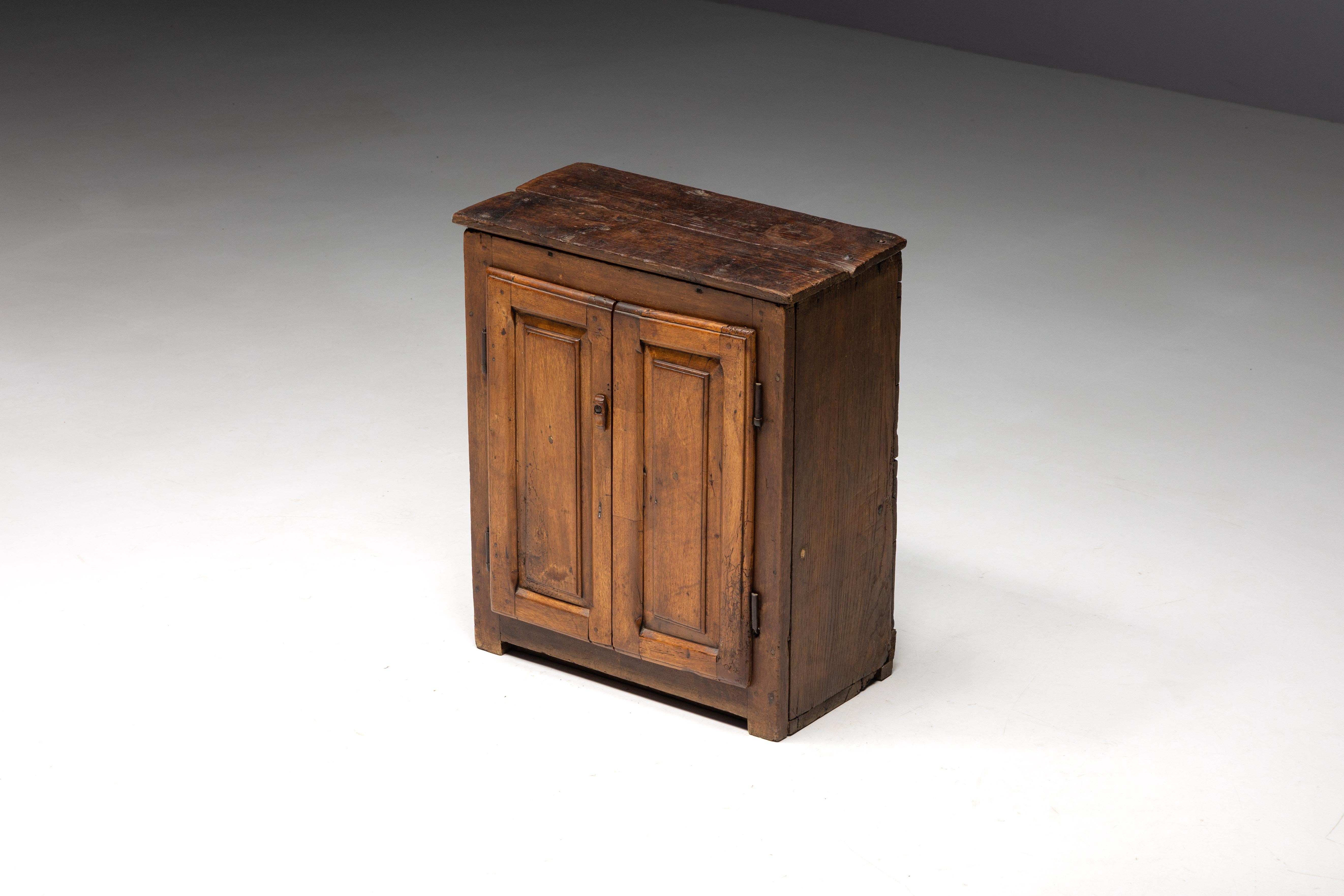 19th-century rustic cupboard handcrafted of solid wood. This piece, formerly used as a 
