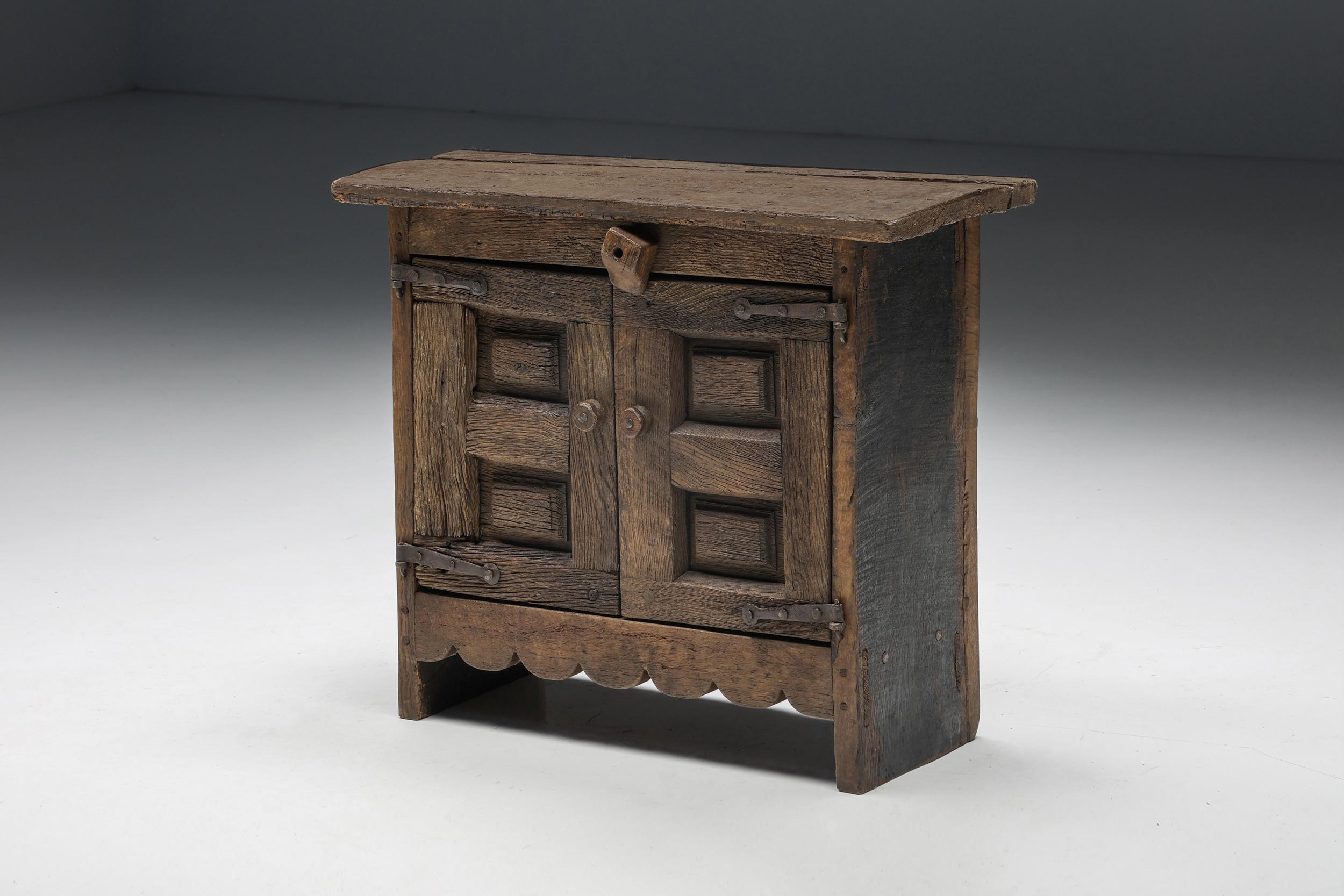 Robust; rustic; two doors; cabinet; storage; storage unit; wood; wabi sabi; france; 1940s; travail populaire; folk art; hand carved; organic; art populaire; 

Travail populaire folk art two-doors cabinet, made in France in the 1940s. A rustic and
