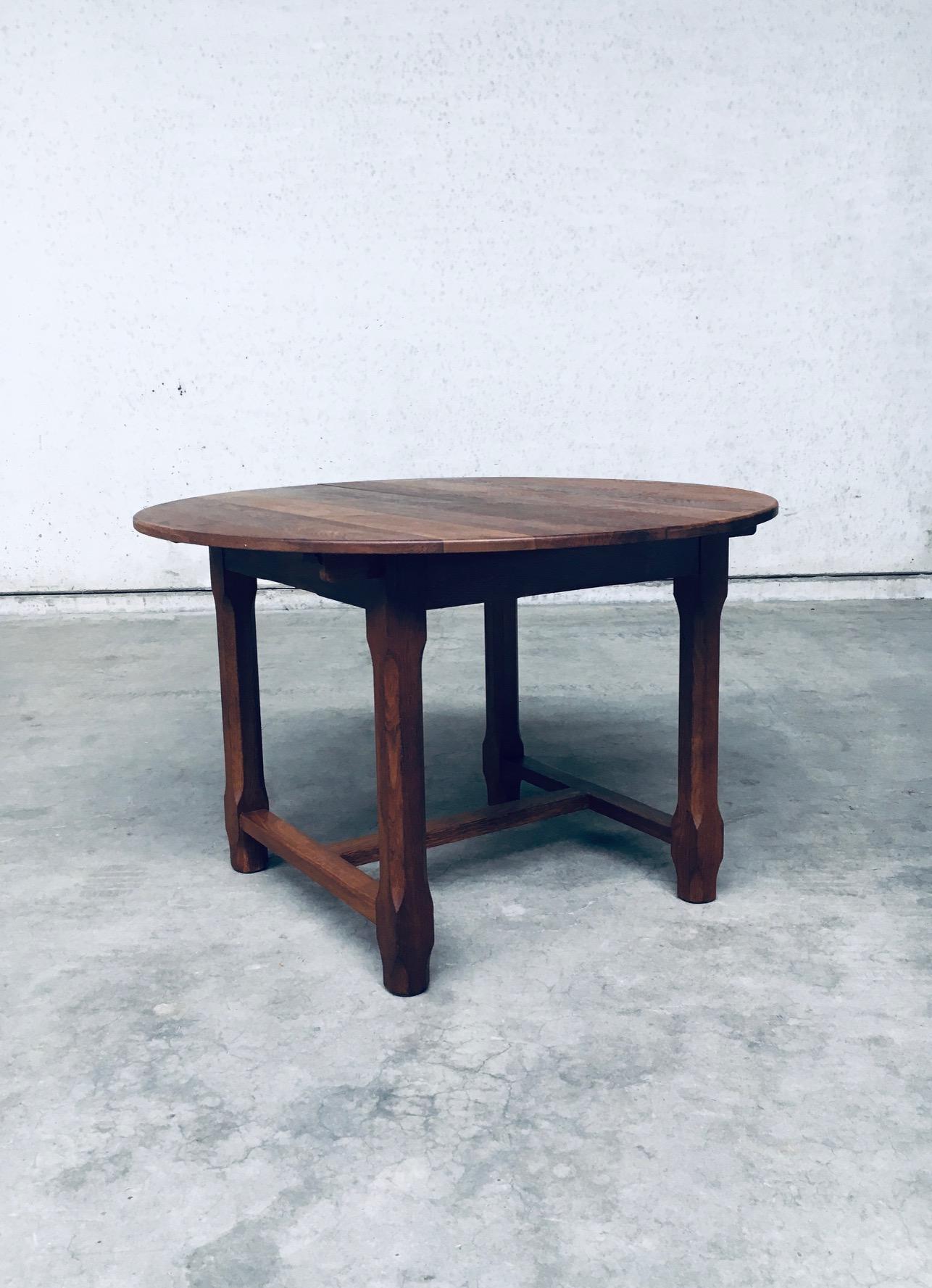 Vintage Handcrafted Design Travail Populaire Solid Oak Extendable Round Dining Table. Made in France, 1930's / 40's period. Designed and made in the style of Guillerme et Chambron. Solid oak constructed table that extends from a round table to an